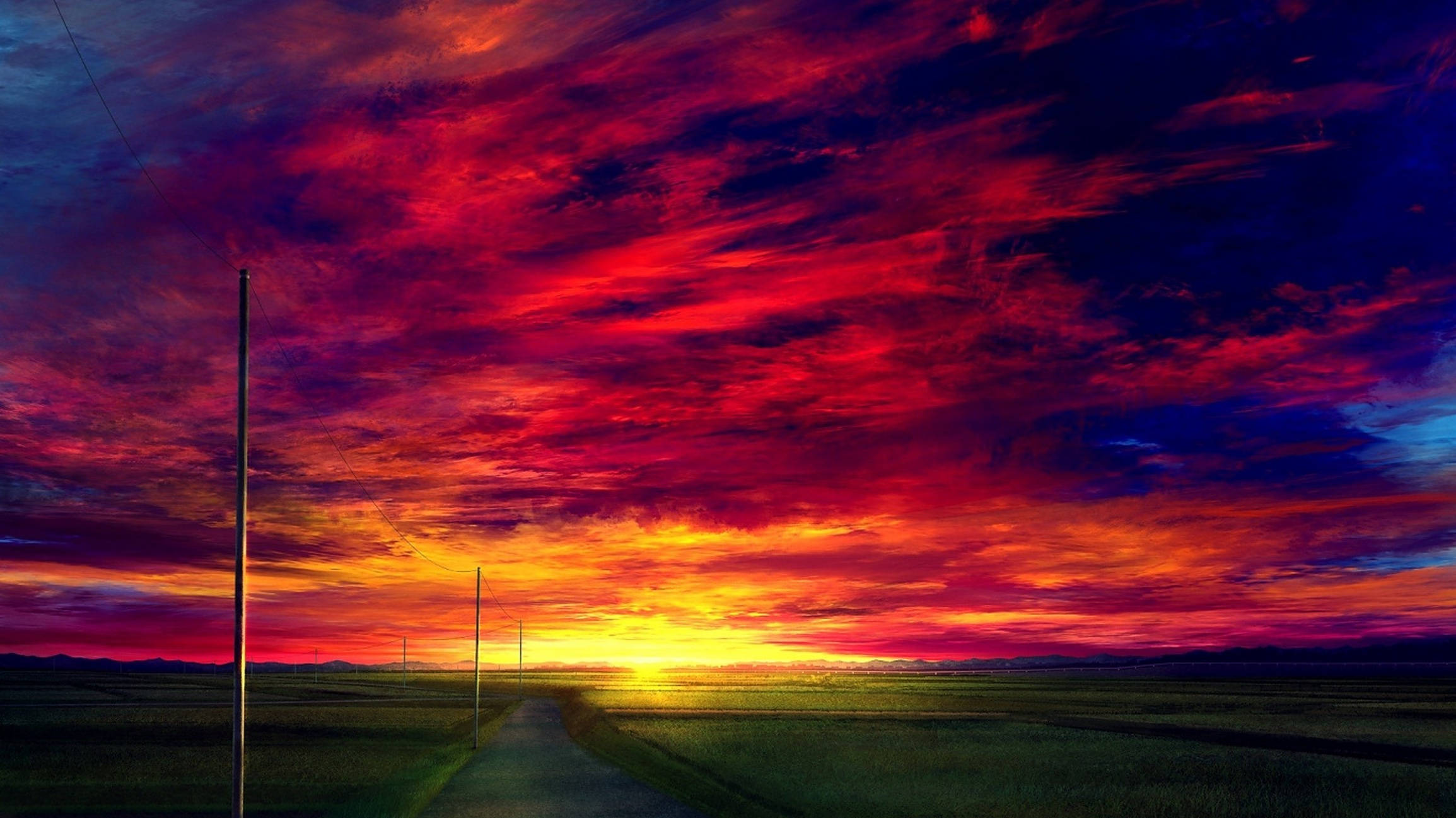 夕陽天空 桌布 壁紙 — 一條蜿蜒的道路穿過廣闊的田野，上方是火燒般的日落天空，塗滿了鮮豔的紅色、橙色和深紫色。