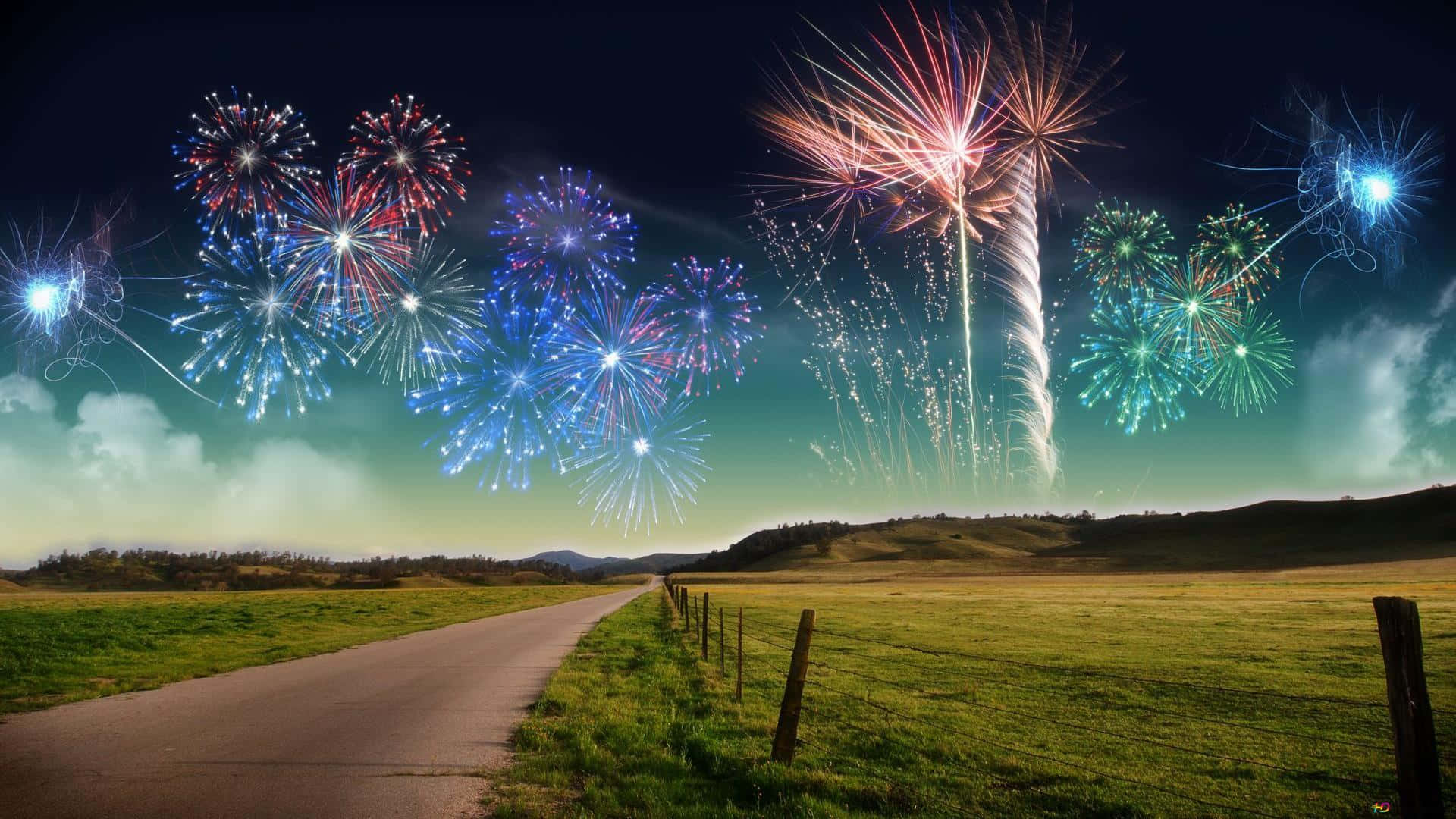 彩色動圖 桌布 壁紙 — 一條蜿蜒的道路穿過草地，天空爆發出鮮豔的紅色、藍色和綠色煙火。