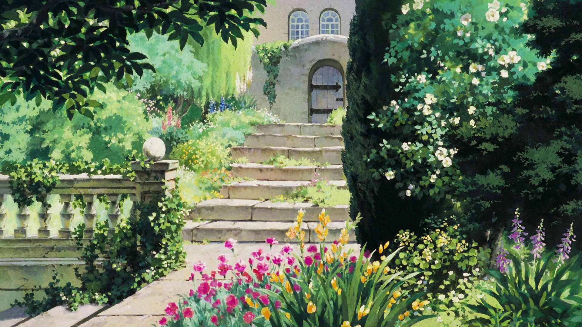 Studio 桌布 壁紙 — 一條陽光普照的花園小徑，石階通往一座由茂密綠植和盛開鮮花環繞的質樸石屋。
