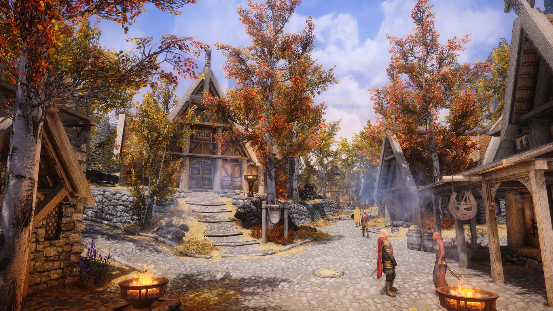 Skyrim Whiterun 桌布 壁紙 — 一條鵝卵石村莊街道，兩旁是木屋和秋樹，上方是明亮的藍天。