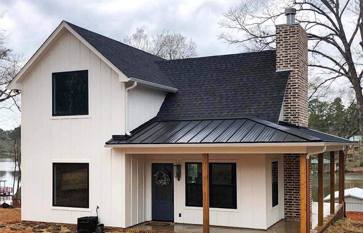 Cottage 桌布 壁紙 — 一棟現代白色農舍，帶有黑色金屬屋頂和磚砌煙囪，矗立在陰天平靜的湖邊。