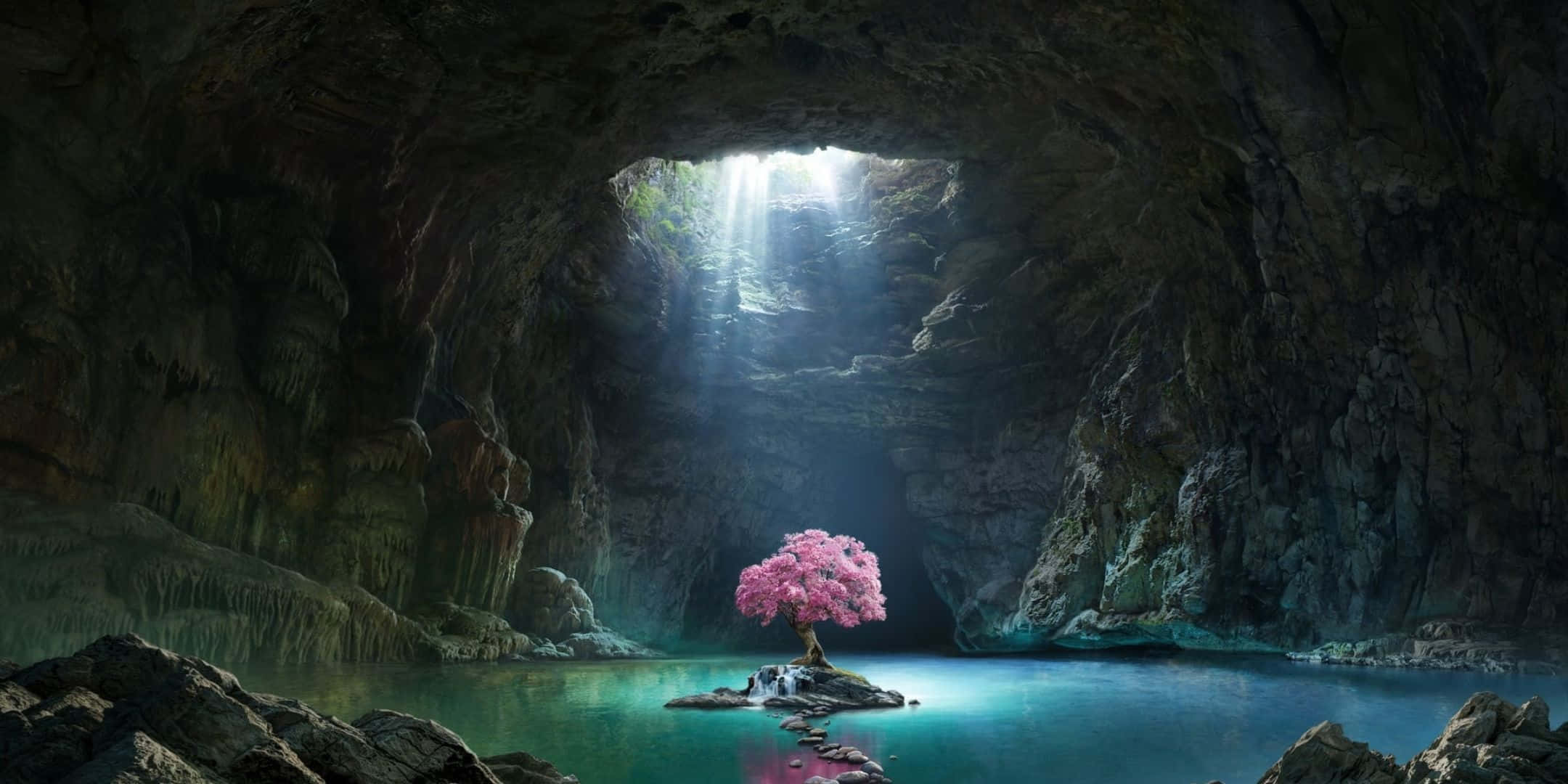 2160x1080 桌布 壁紙 — 一棵孤獨的粉紅色開花樹矗立在一塊岩石上，位於寧靜的綠松石色洞穴水池中，被從高處開口傾瀉而下的神聖陽光所照亮。