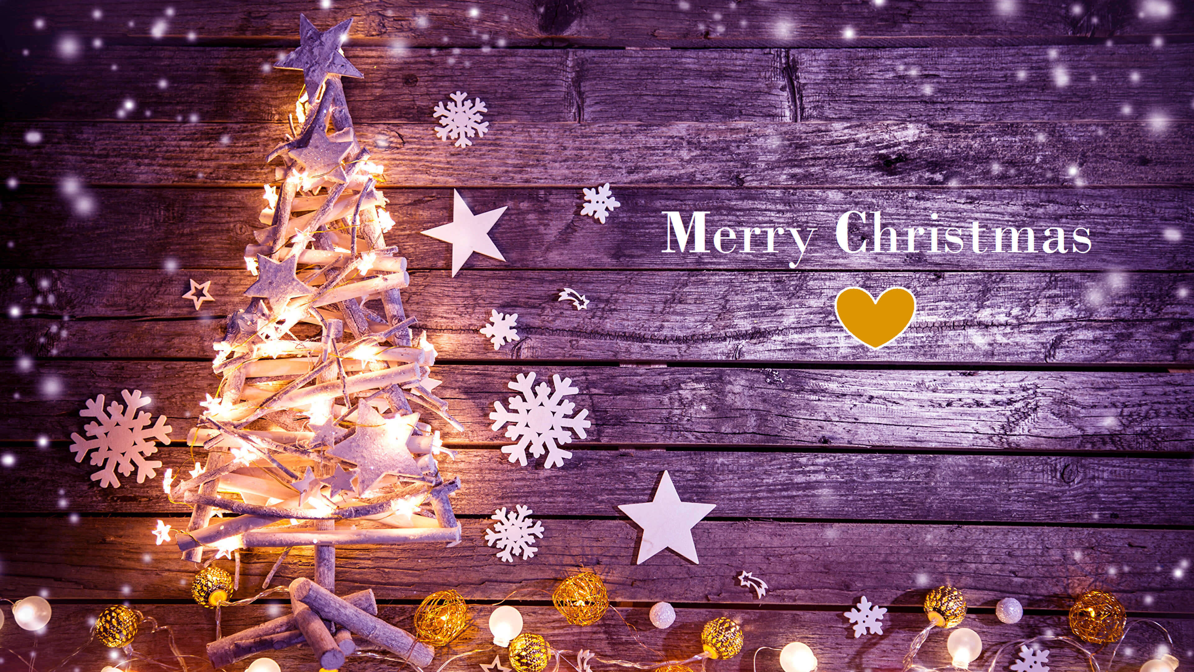 christmas blessings 桌布 壁紙 — 一棵溫暖照亮的樹枝聖誕樹，裝飾著仙女燈和紙雪花，立在質樸的木質背景上，有飄落的雪花和「聖誕快樂」的祝福。