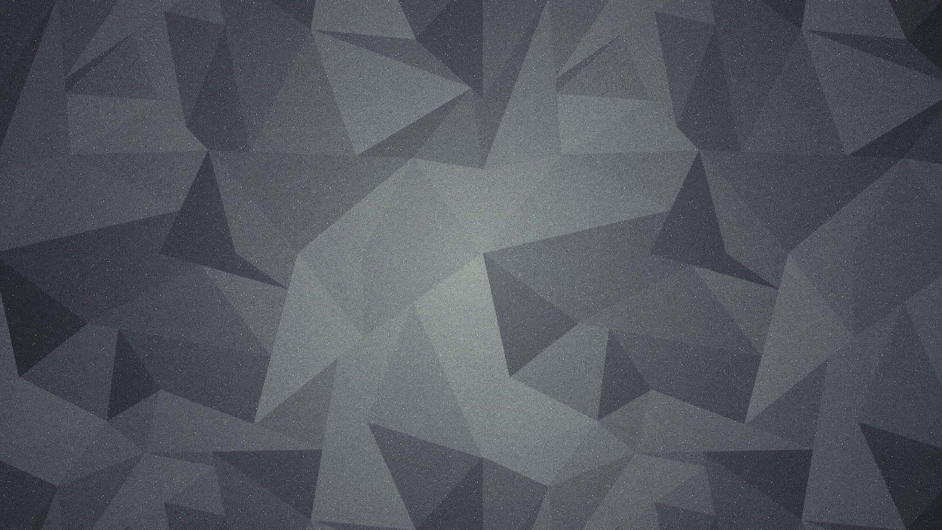Grey Texture 桌布 壁紙 — 一款單色幾何壁紙，以不同灰色調的互鎖三角形創造出現代抽象圖案。