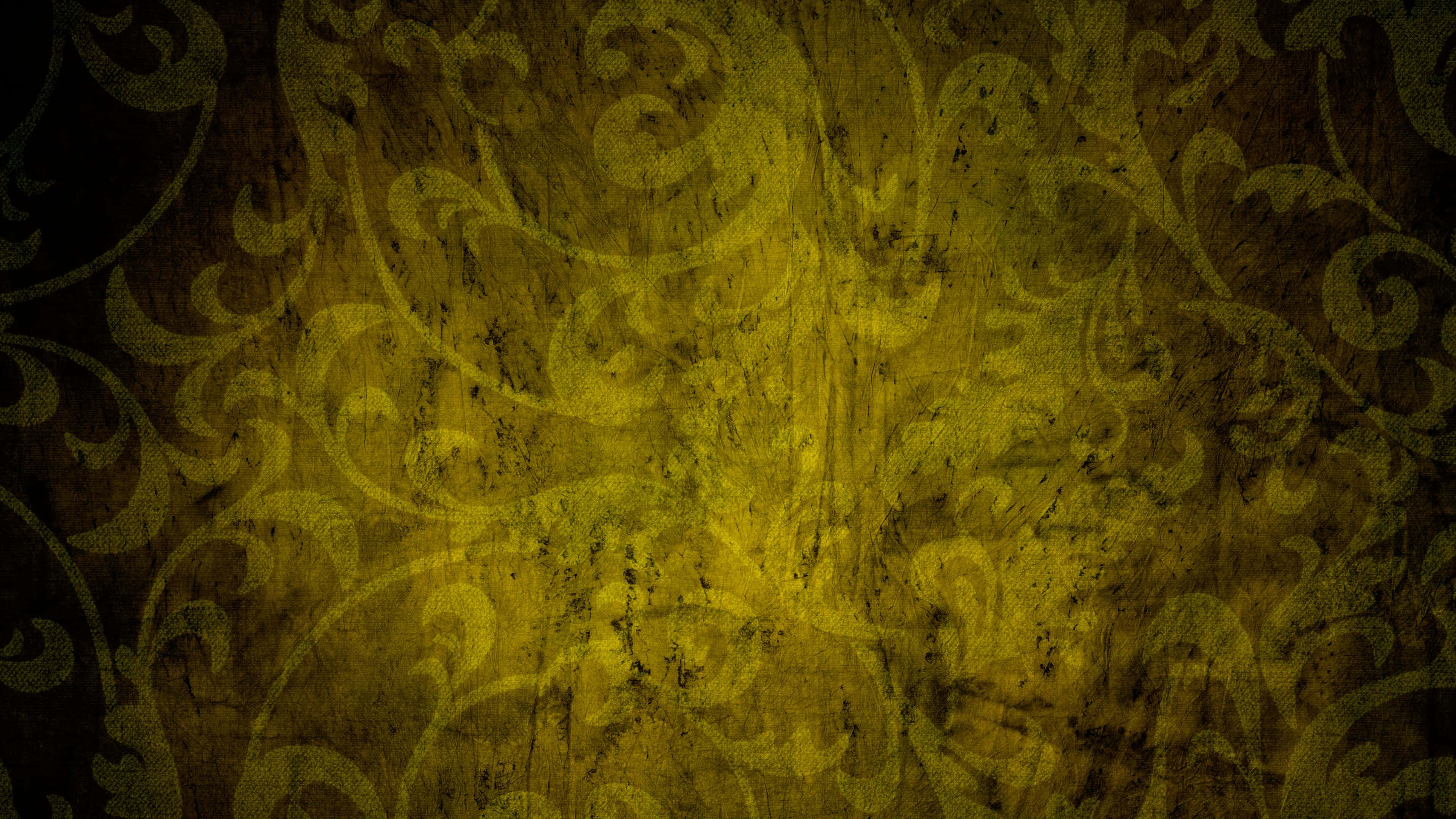 Yellow Grunge 桌布 壁紙 — 一款帶有紋理的壁紙，在深棕色頹廢背景上呈現旋轉的金黃色大馬士革圖案。