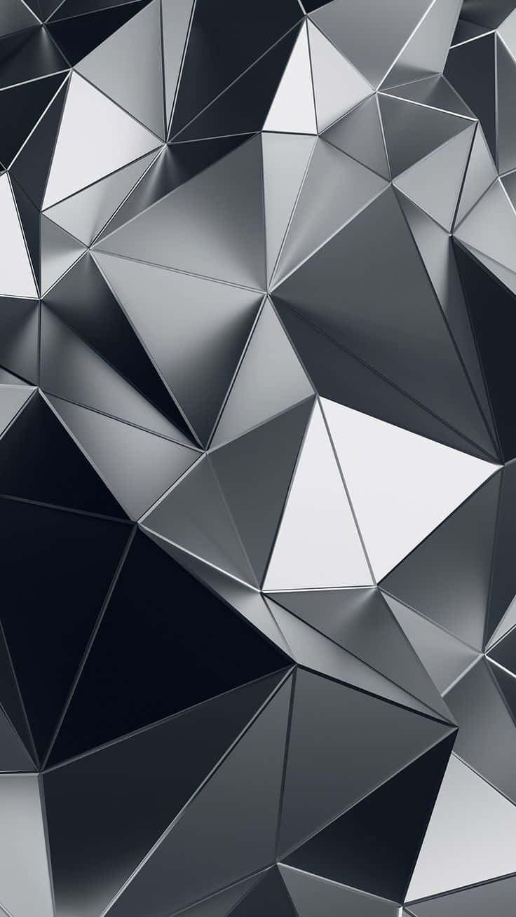 Grey Gradient 桌布 壁紙 — 一款時尚的抽象壁紙，由銀色和黑色的單色調金屬三角形交織而成。