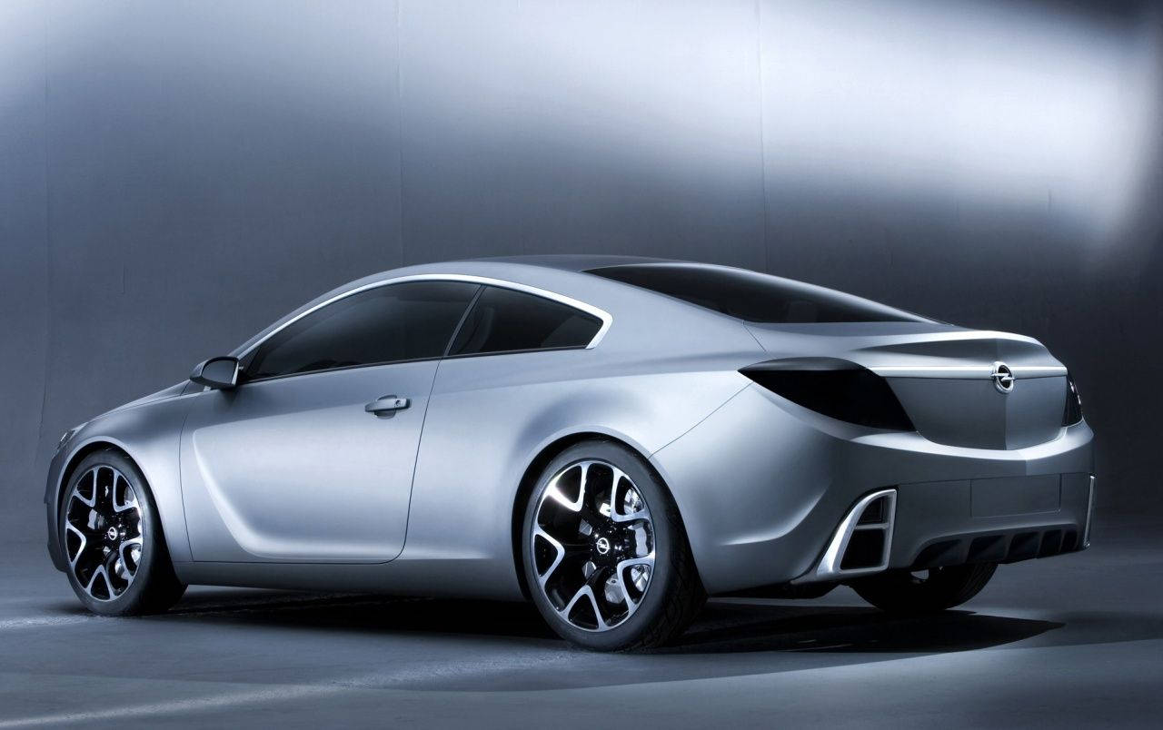 Opel 桌布 壁紙 — 一款時尚的銀色概念轎跑車，帶有黑色裝飾和時尚車輪，在簡約的工作室中展示，光線效果戲劇化。