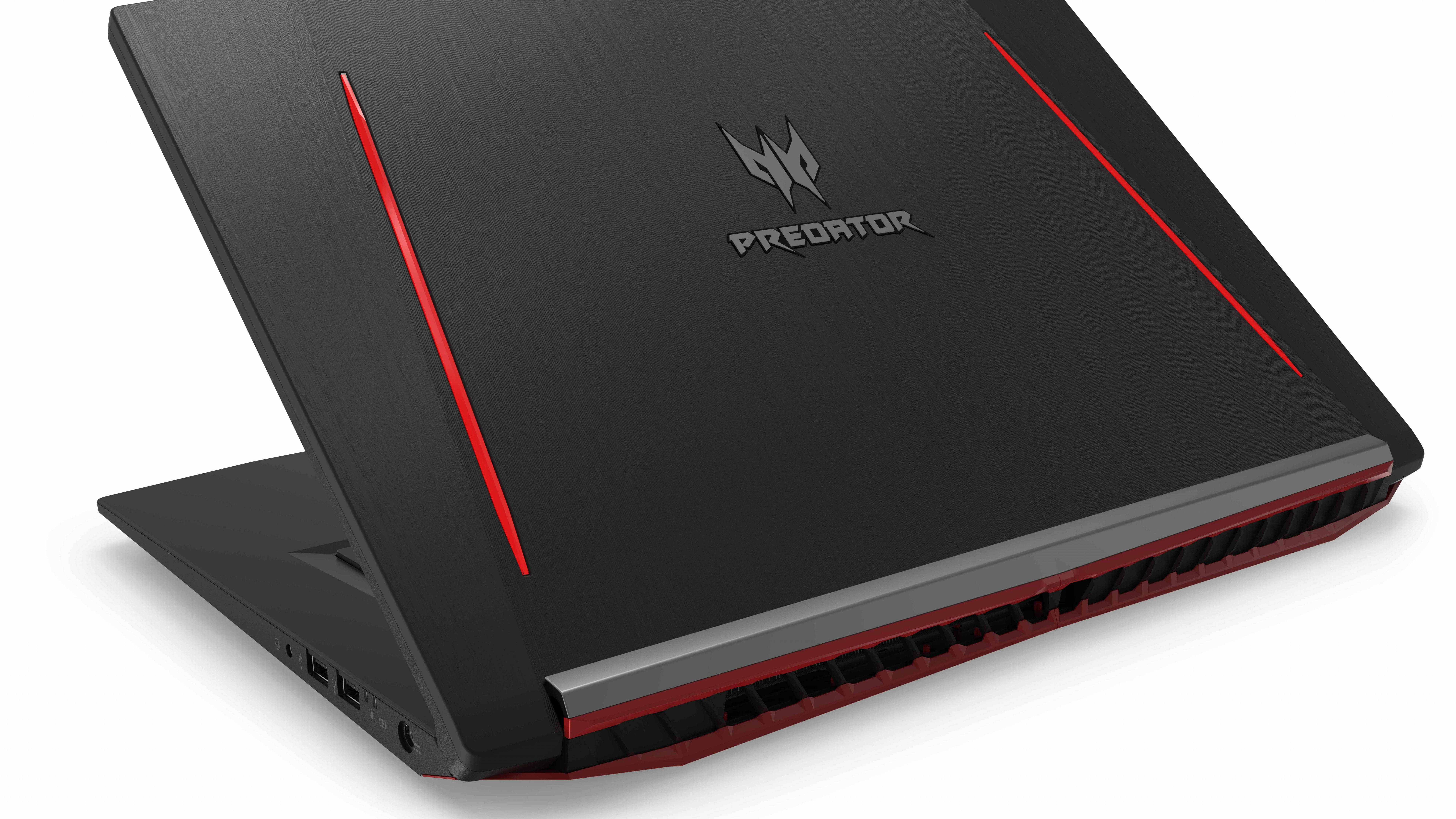 筆電 桌布 壁紙 — 一款時尚的黑色 Acer Predator 電競筆記型電腦，帶有鮮明的紅色點綴和棱角設計，置於純白背景上。