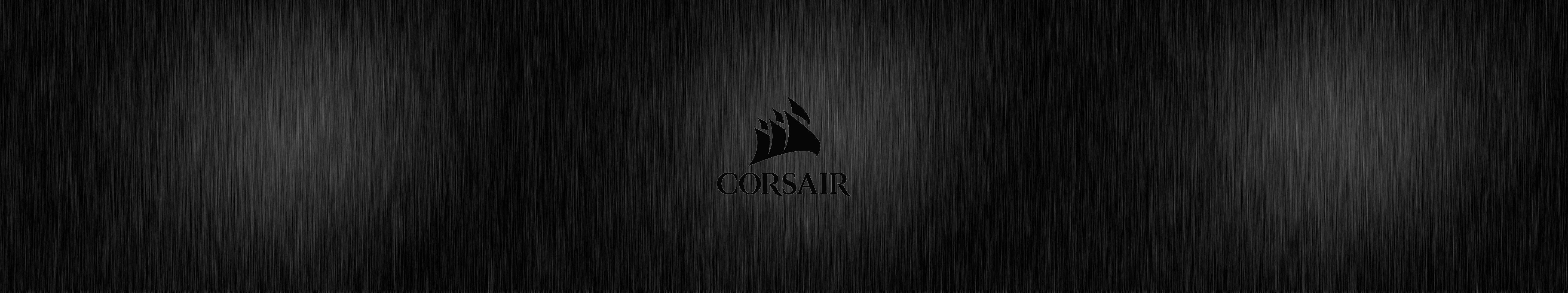 海盜船 桌布 壁紙 — 一款時尚的黑色拉絲金屬壁紙，中央帶有Corsair標誌，並帶有微妙的漸變燈光。