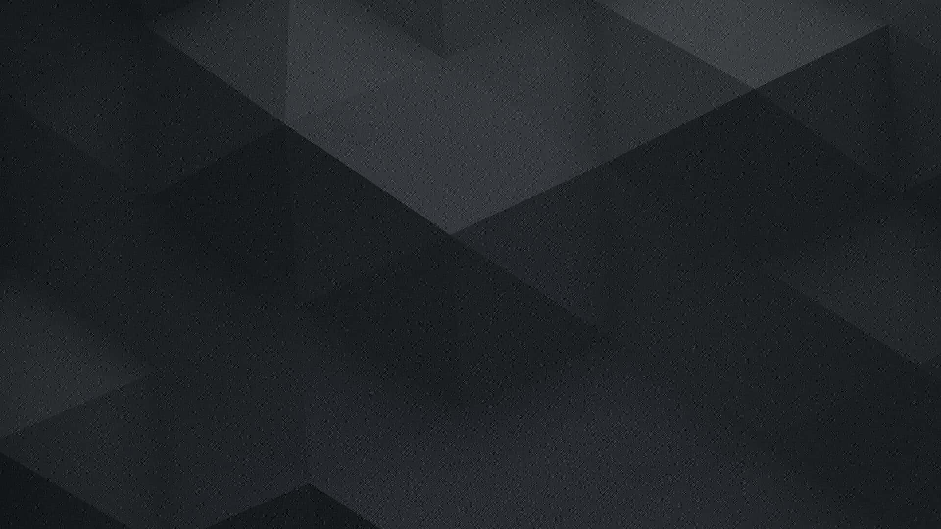 Minimalist Geometric 桌布 壁紙 — 一款極簡抽象壁紙，以深灰色幾何三角形搭配柔和漸變和細微陰影為特色。