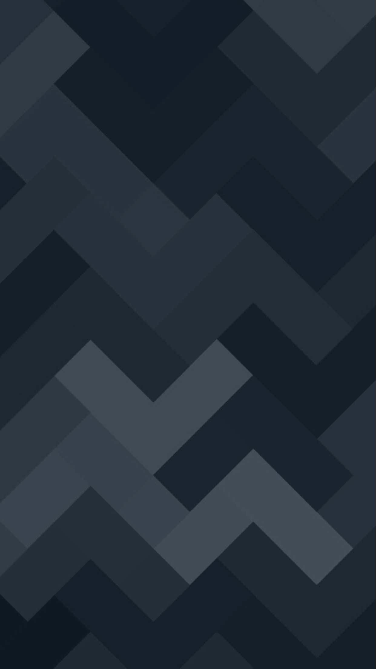 Minimalist Geometric 桌布 壁紙 — 一款極簡數位桌布，具有重複的V形圖案，採用深藍色和灰色的不同色調。