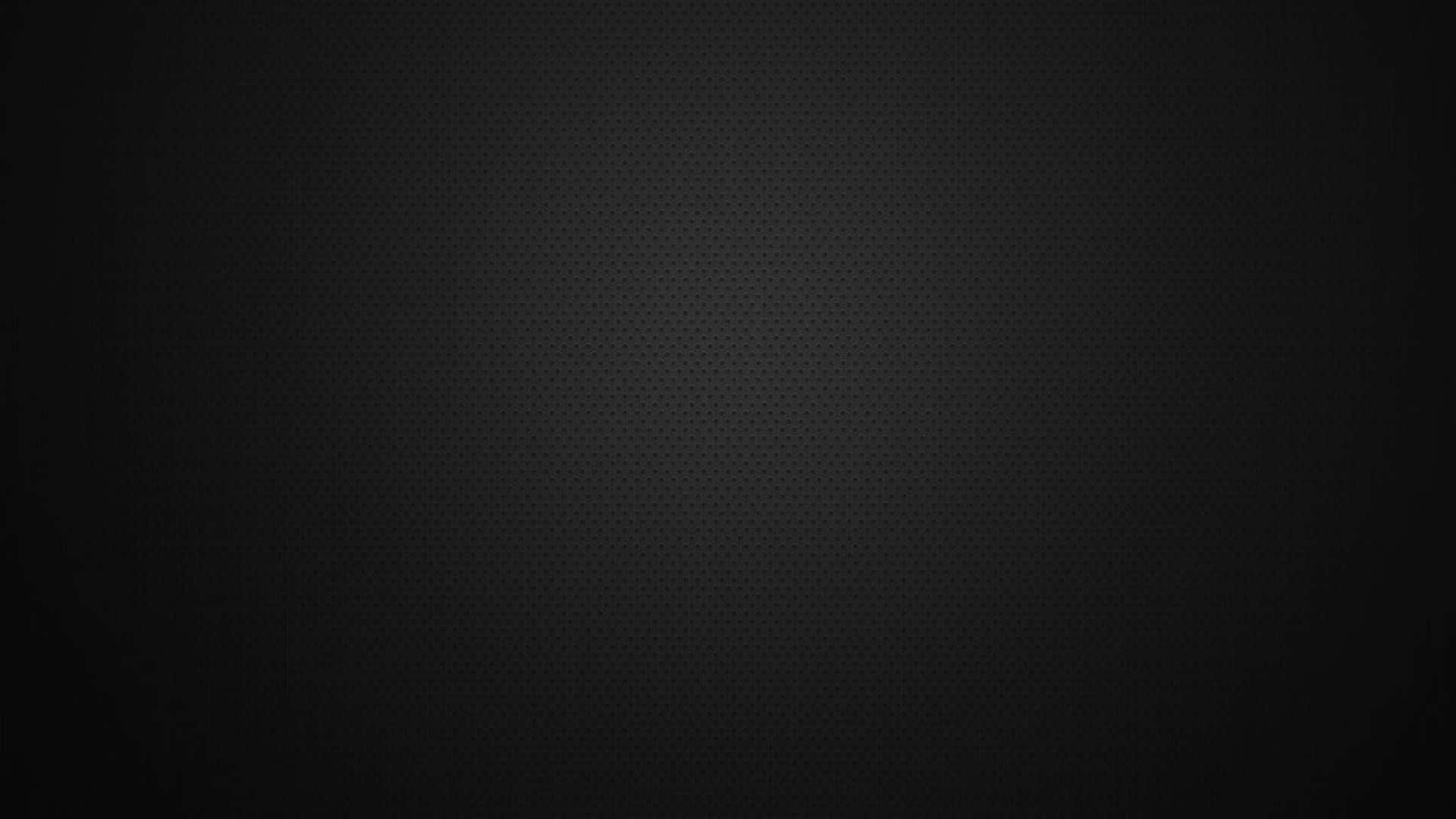 Plain Black Desktop 桌布 壁紙 — 一款極簡深灰色桌布，帶有微妙的六邊形紋理漸變，向黑色邊緣淡出。