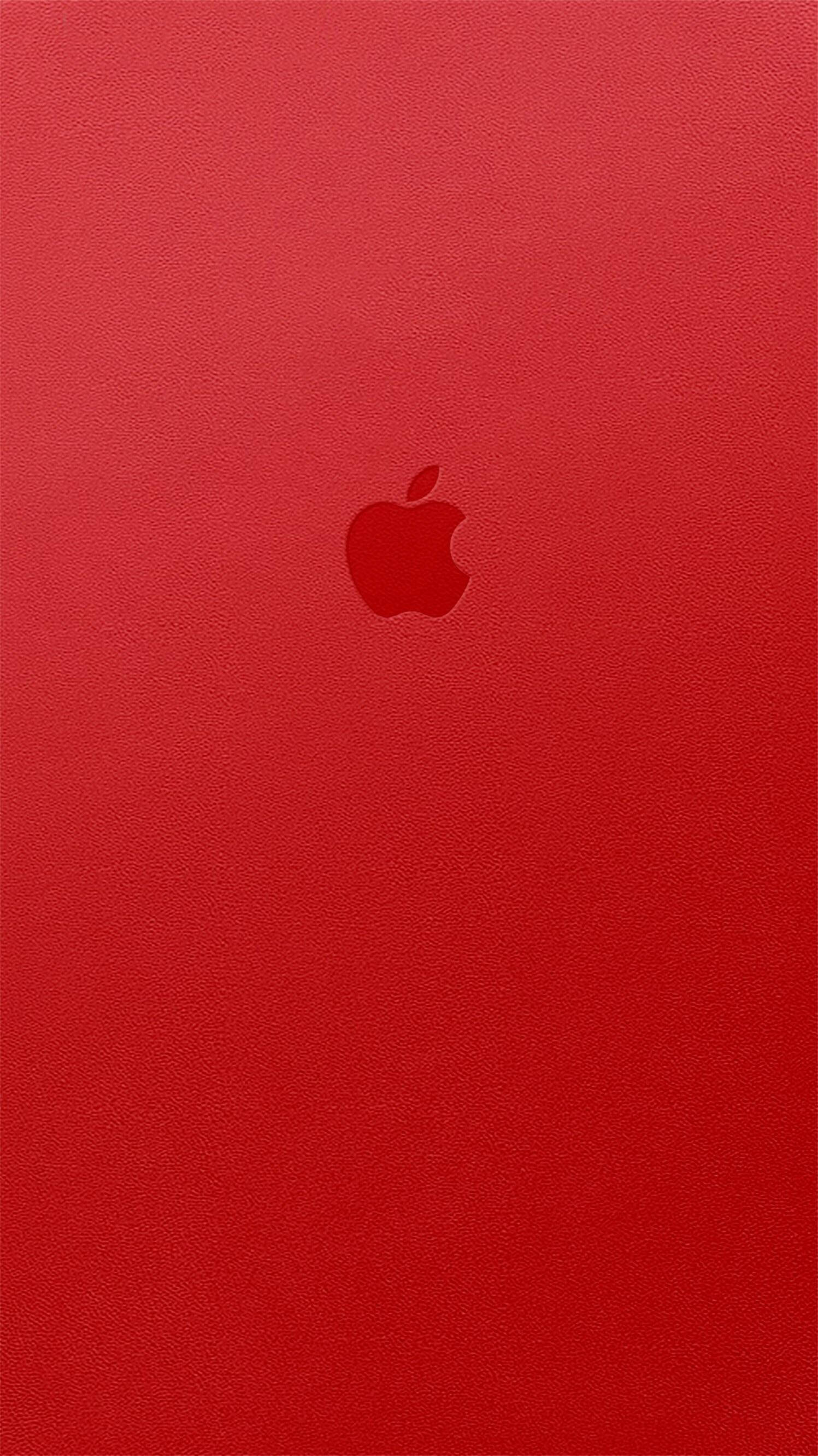 紅色 iPhone 桌布 壁紙 — 一款極簡的紅色紋理壁紙，中央有一個微妙的Apple標誌，背景統一。