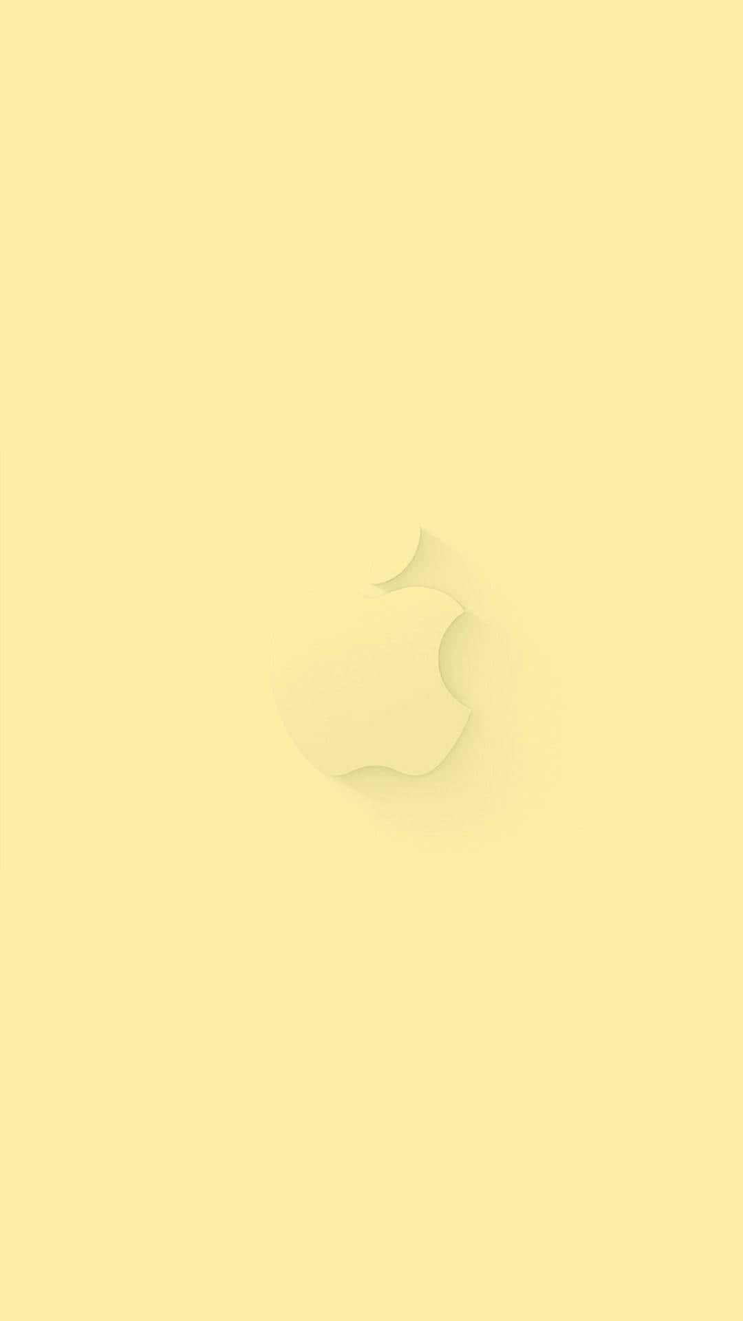 桌布 壁紙 — 一款極簡風格的淡黃色桌布，中央帶有微妙的Apple標誌，並帶有柔和陰影效果，背景純色。