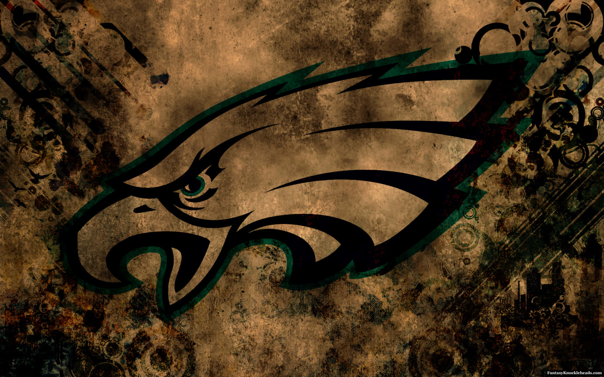 Eagles Football 桌布 壁紙 — 一款粗糙紋理的壁紙，以黑色和綠色的風格化鷹標誌，襯托風化的棕色背景。