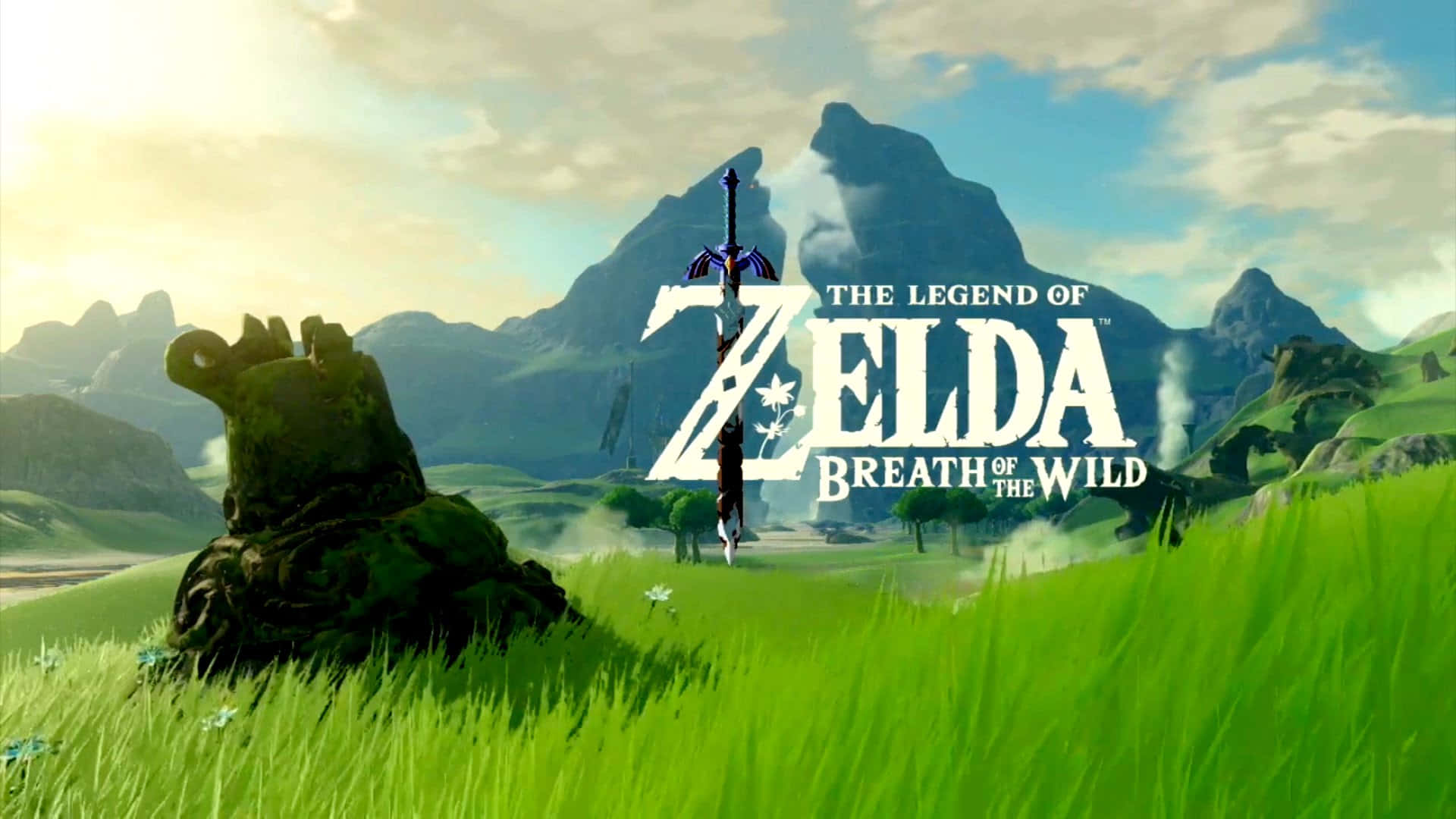 Botw 桌布 壁紙 — 一片充滿活力的綠色田野，有長滿青苔的石像和遠處的山脈，在明亮的天空下，帶有《薩爾達傳說 曠野之息》標誌。