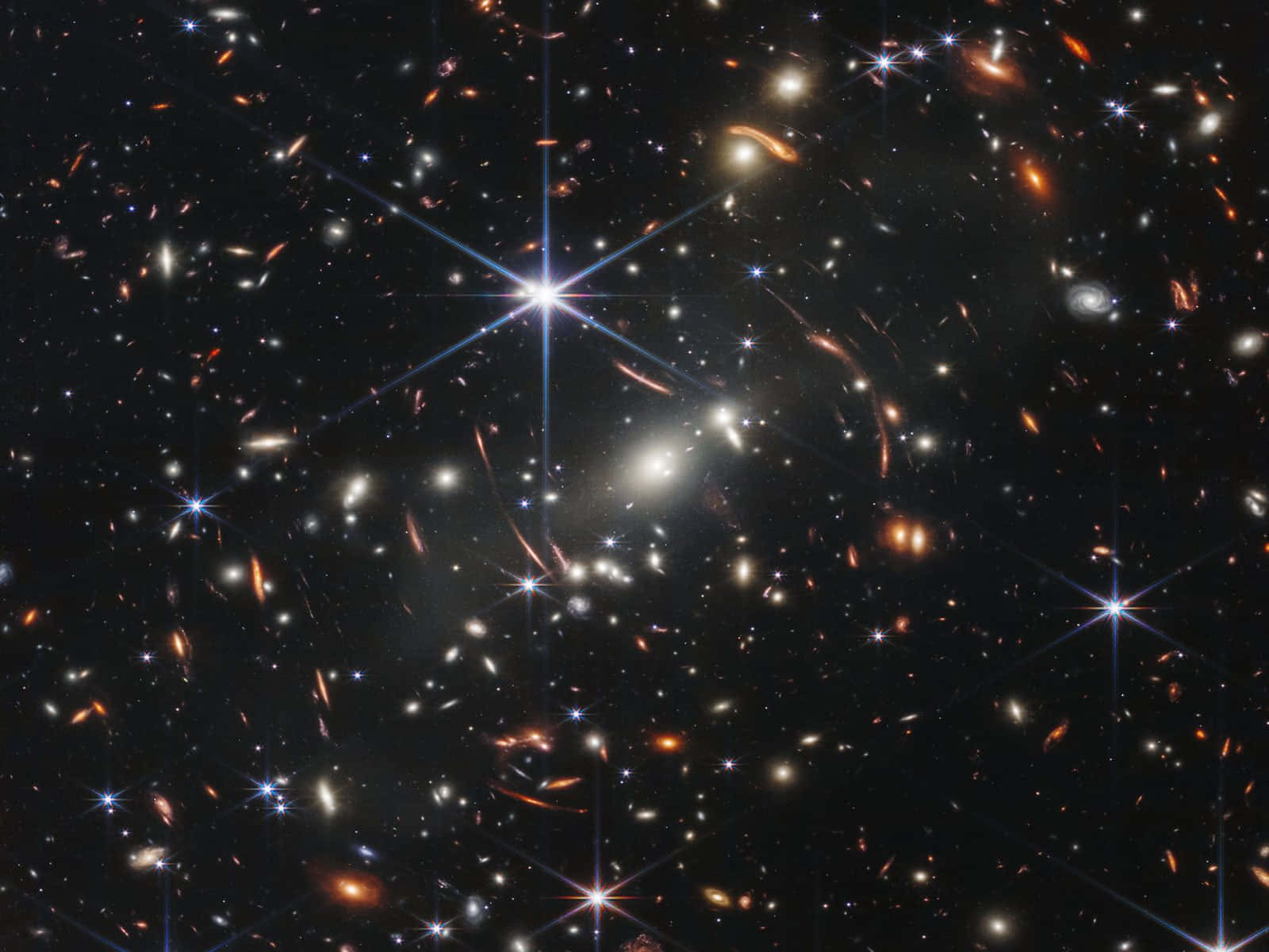 Stars 桌布 壁紙 — 一片宇宙景觀，充滿發光的星系和明亮的星星，背景是深邃的黑色虛空。