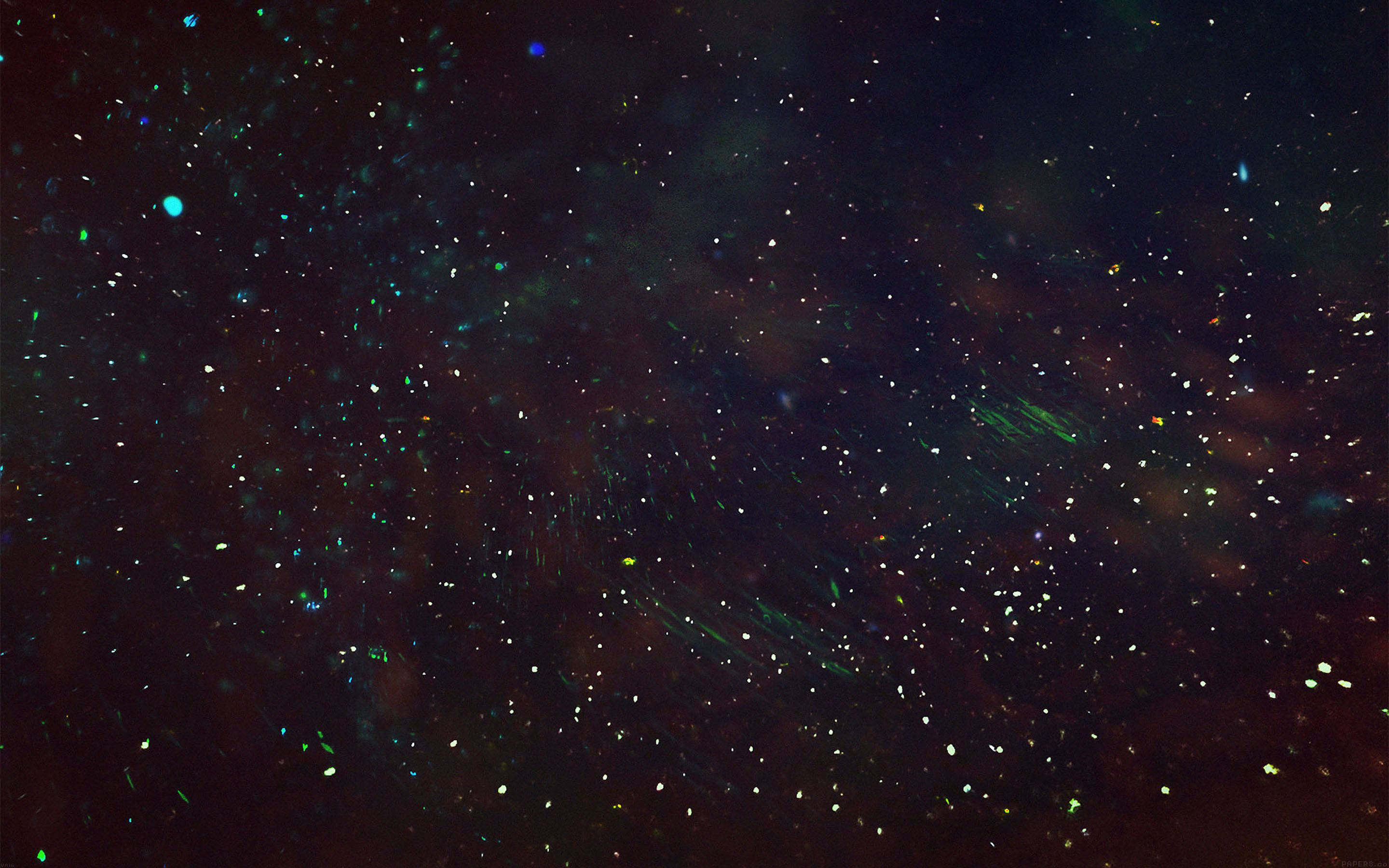 Star Space 桌布 壁紙 — 一片宇宙空間，充滿了在黑暗太空中飄浮的發光綠色和藍色粒子。