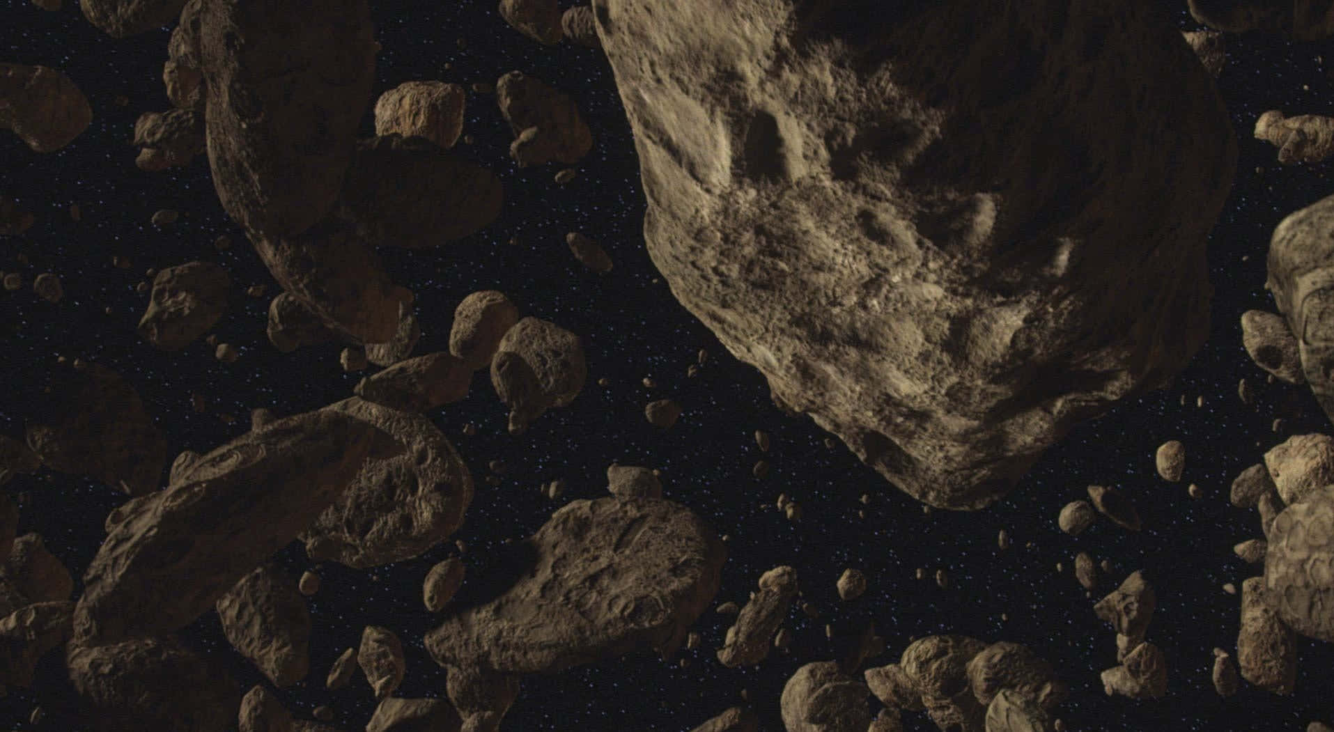 Star Wars Space 桌布 壁紙 — 一片密集的崎嶇小行星在昏暗環境光下，飄過佈滿星星的虛空。