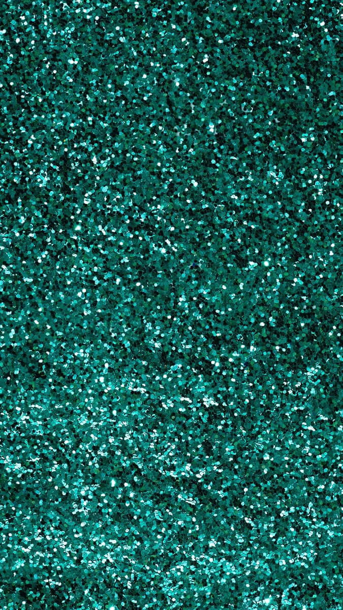 Turquoise Green 桌布 壁紙 — 一片密集閃爍的藍綠色亮粉，營造出帶有明亮反光高光的閃爍紋理表面。