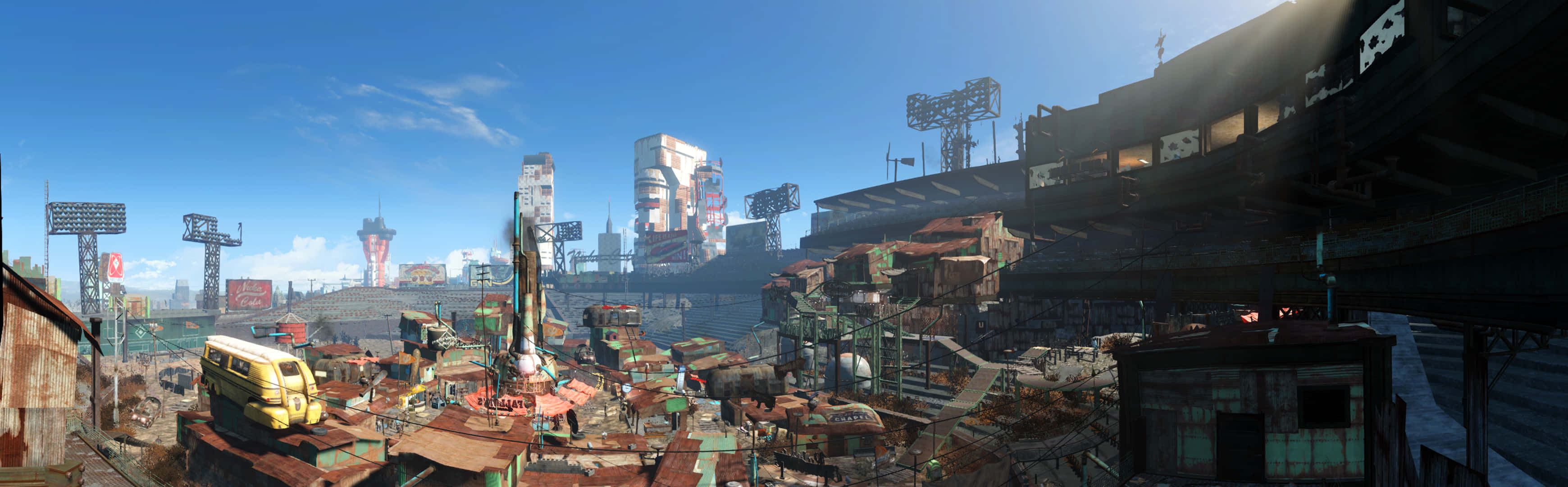 Diamond City 桌布 壁紙 — 一片廣闊的未來城市景觀，在明亮的藍天下，有破舊的建築和高聳的結構。