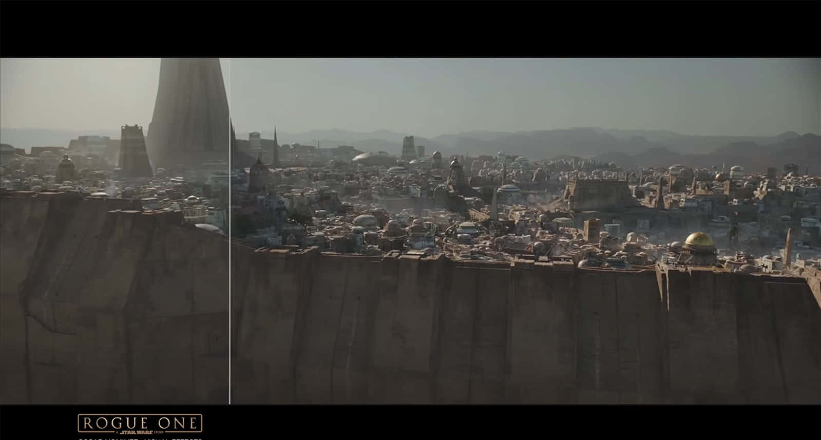 Jedha 桌布 壁紙 — 一片廣闊的沙漠城市景觀，高聳的建築物和圓頂建築在朦朧的天空下。