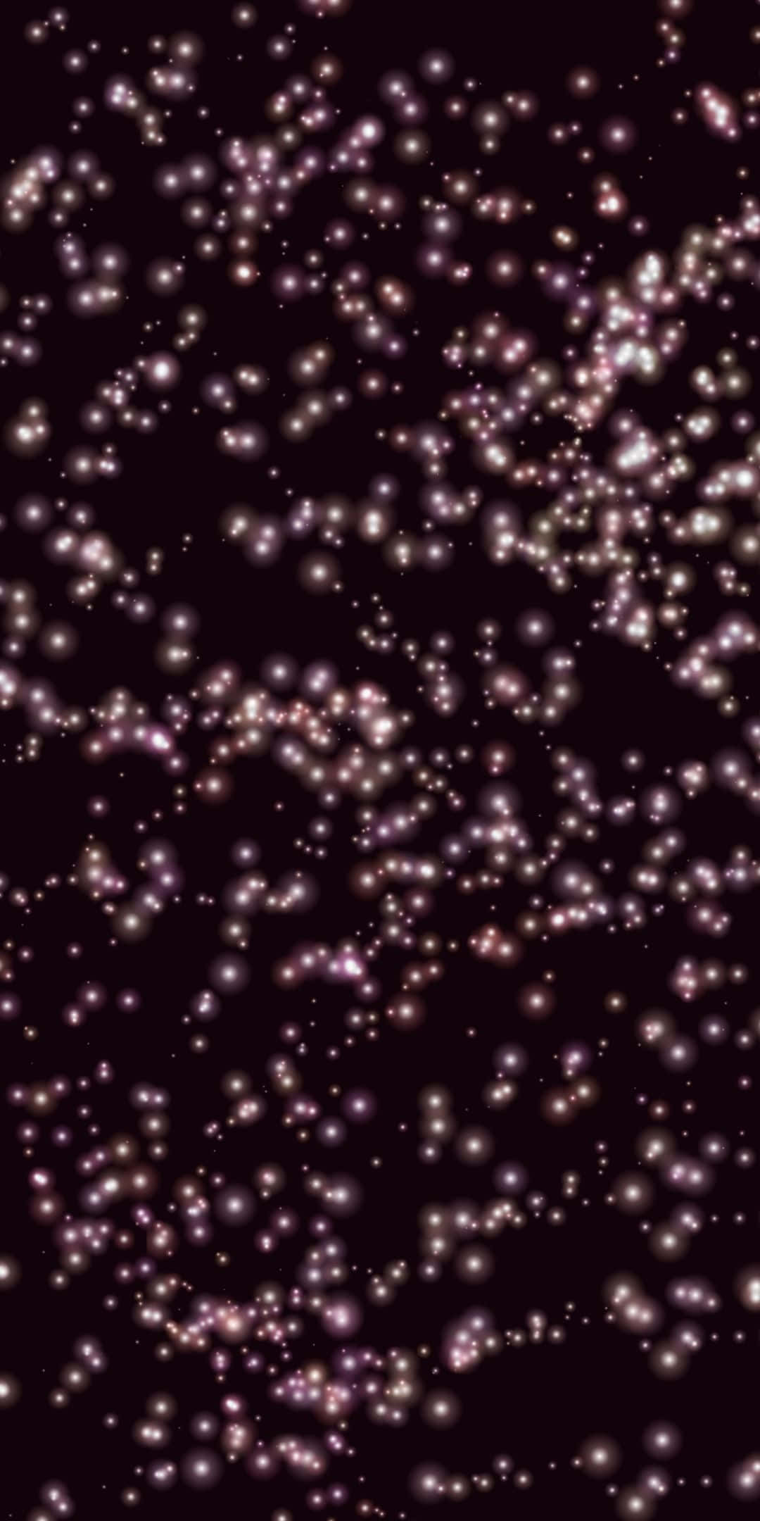 Sparkle Aesthetic 桌布 壁紙 — 一片發光的粉白色球體在深栗色背景上漂浮，如同飄浮的宇宙塵埃。