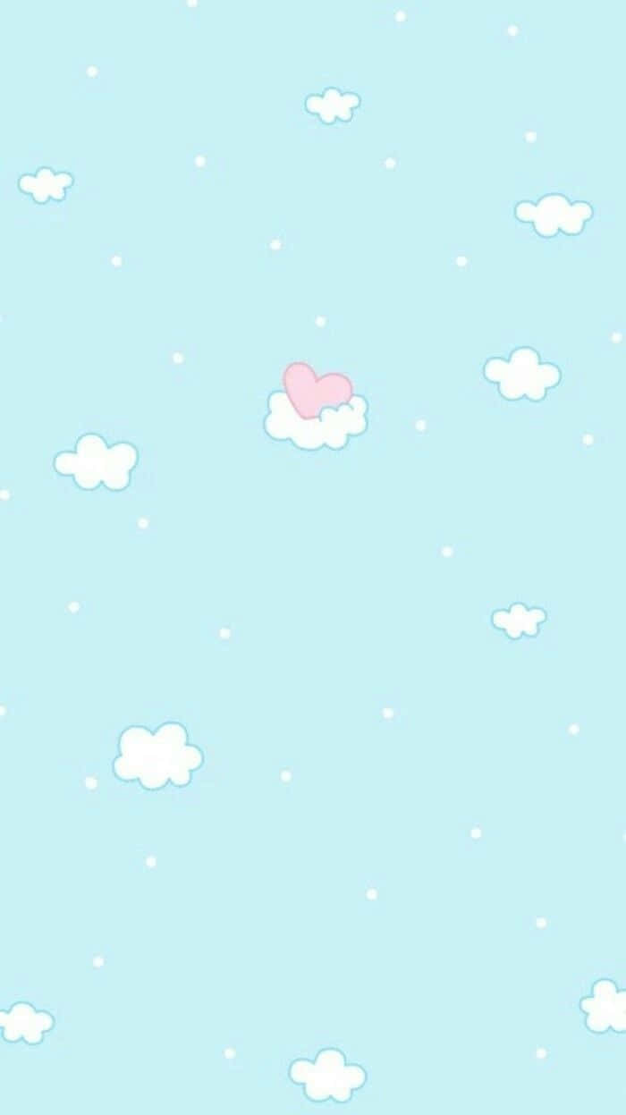 Pastel Blue And Pink 桌布 壁紙 — 一片粉藍色的天空，點綴著 fluffy 白色雲朵和一朵粉紅色的心形雲。