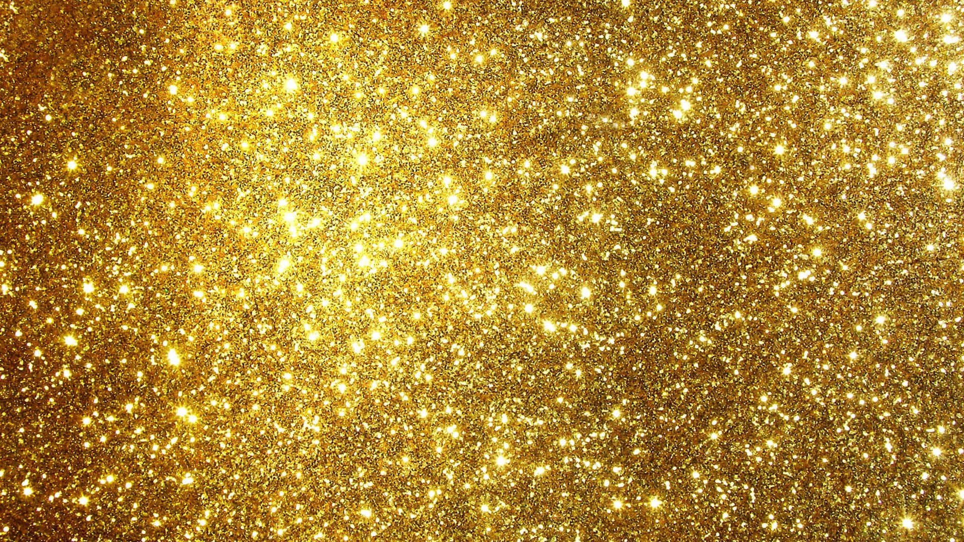 Yellow Glitter 桌布 壁紙 — 一片閃爍的金色亮粉場地，在閃爍的紋理表面上閃耀著明亮的閃光。