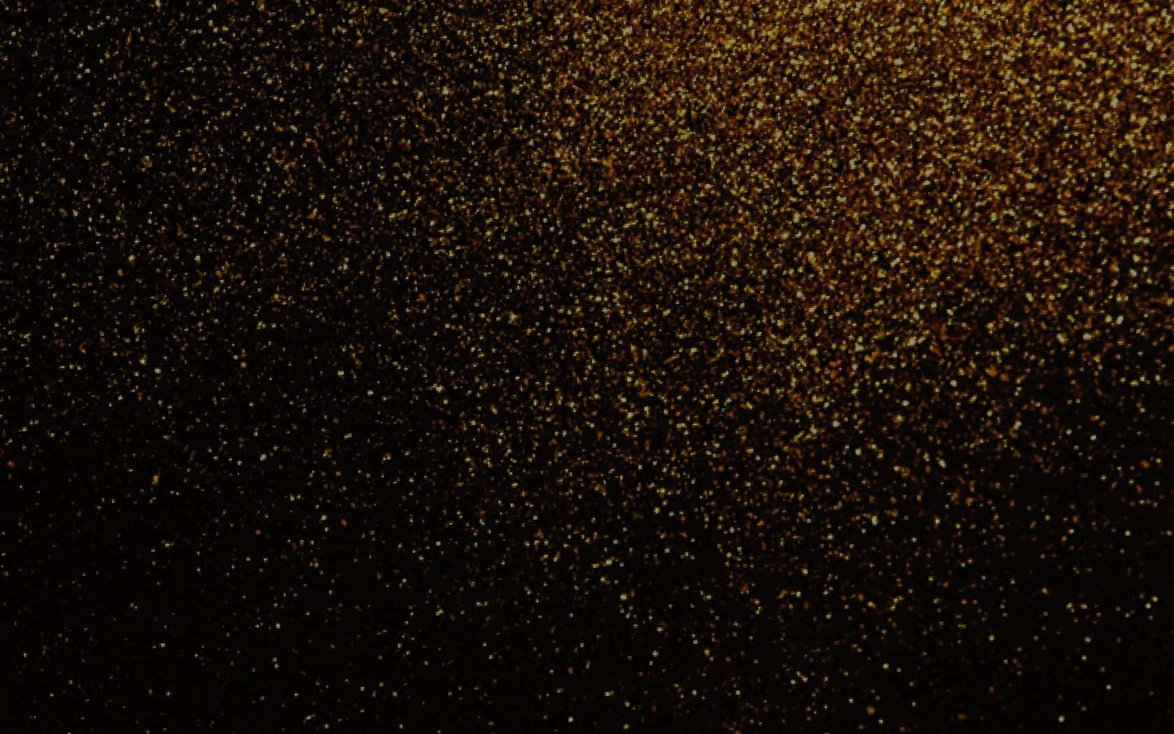 Black And Gold Glitter 桌布 壁紙 — 一片閃爍的金色亮粉粒子在深黑色背景上對角線傾瀉而下。