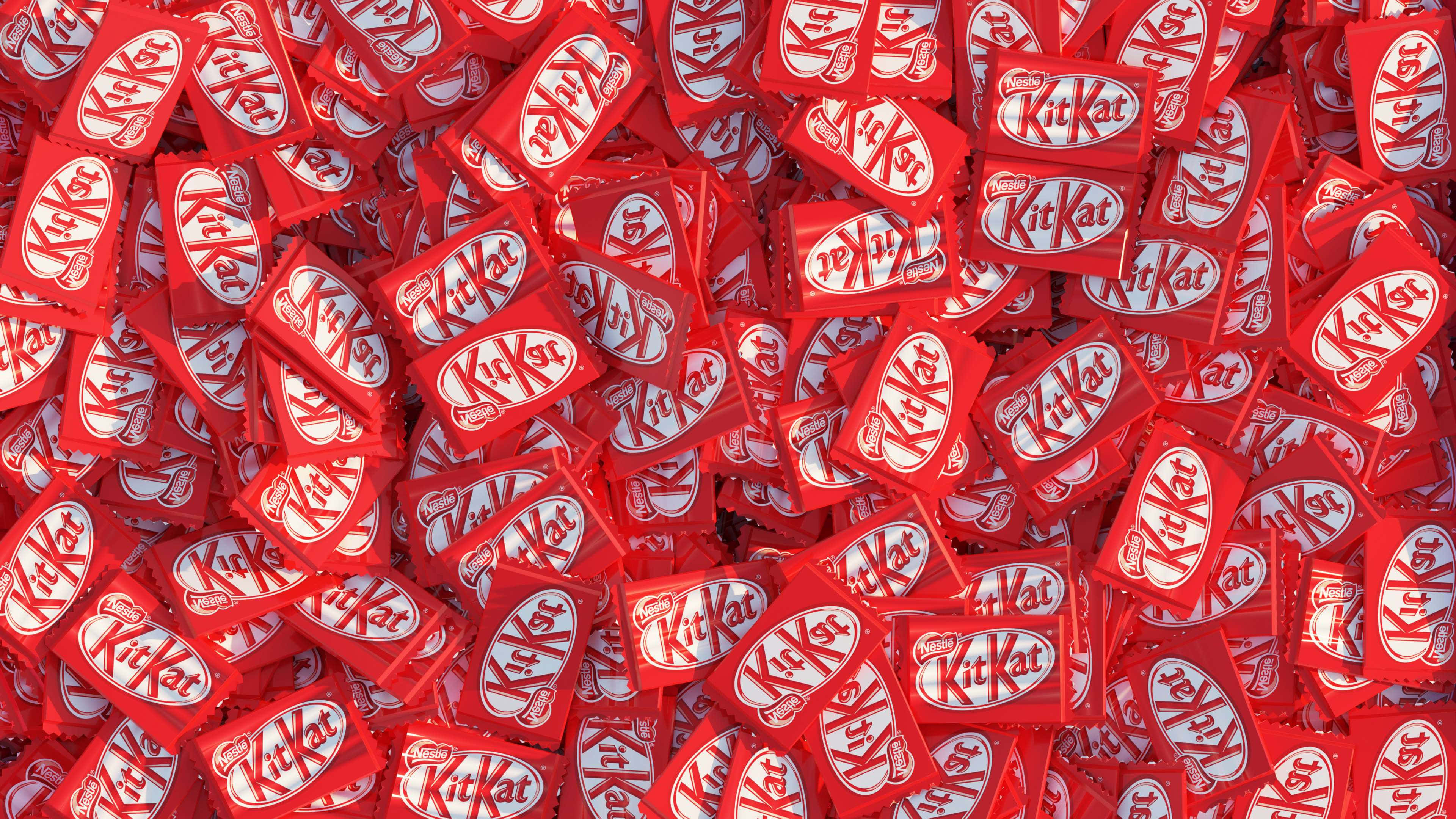 Chocolate 桌布 壁紙 — 一片鮮紅的KitKat巧克力棒以密集重疊的圖案填滿畫面。