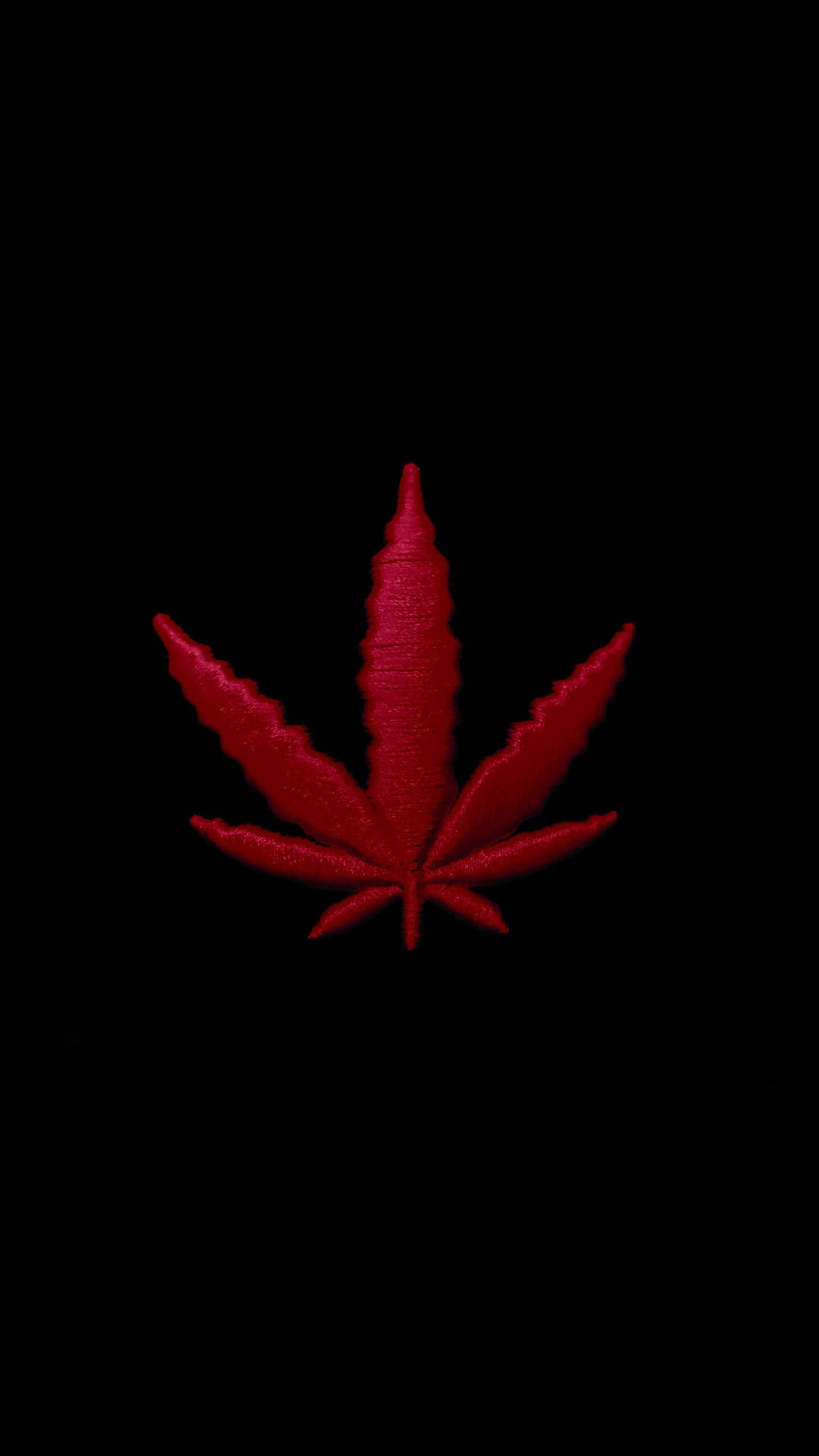紅色動圖 桌布 壁紙 — 一片鮮紅的大麻葉，帶有紋理縫線，居中置於純黑背景上。