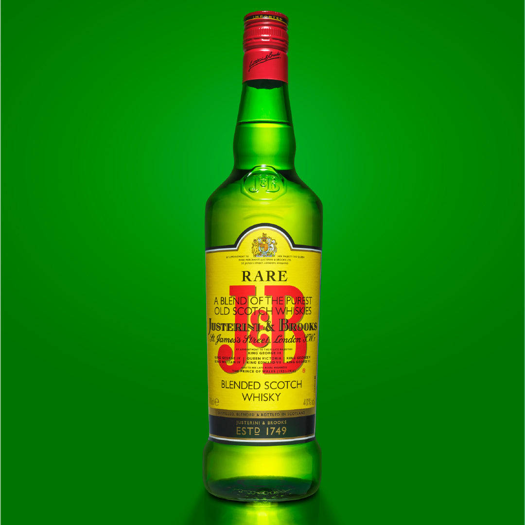 drinks 桌布 壁紙 — 一瓶Justerini & Brooks Rare Blended Scotch Whisky的綠色玻璃瓶，置中於純色鮮綠色背景前。