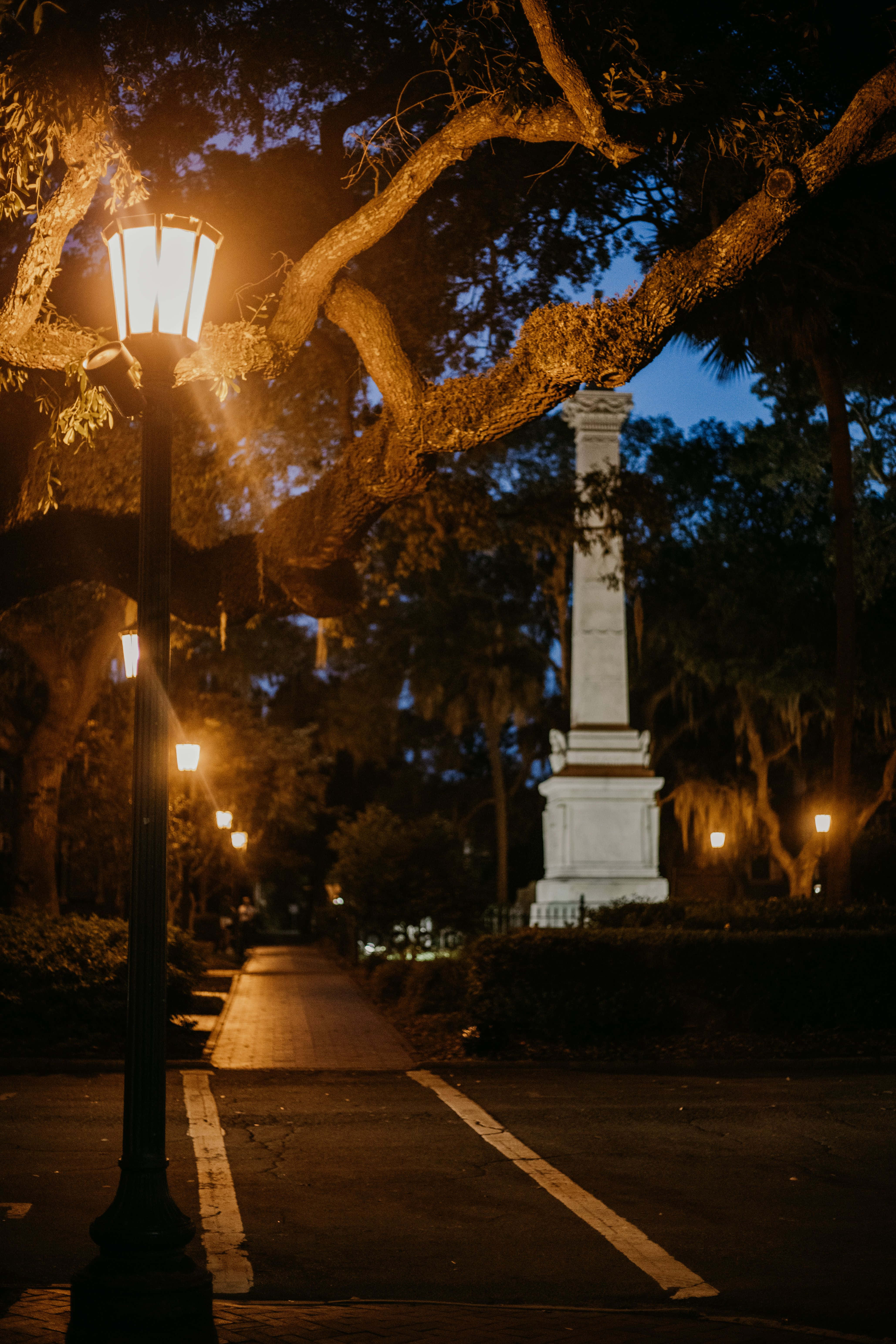 Savannah 桌布 壁紙 — 一盞溫暖的街燈照亮了一條通往白色紀念碑的樹蔭小徑，天空呈現暮色。