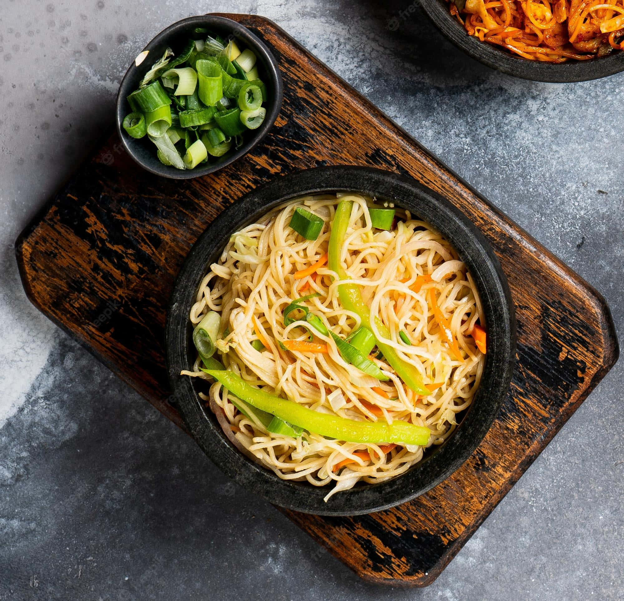 Food Photography 桌布 壁紙 — 一碗冒煙的炒麵，搭配青蔥、紅蘿蔔和甜椒，放在質樸的木板上。