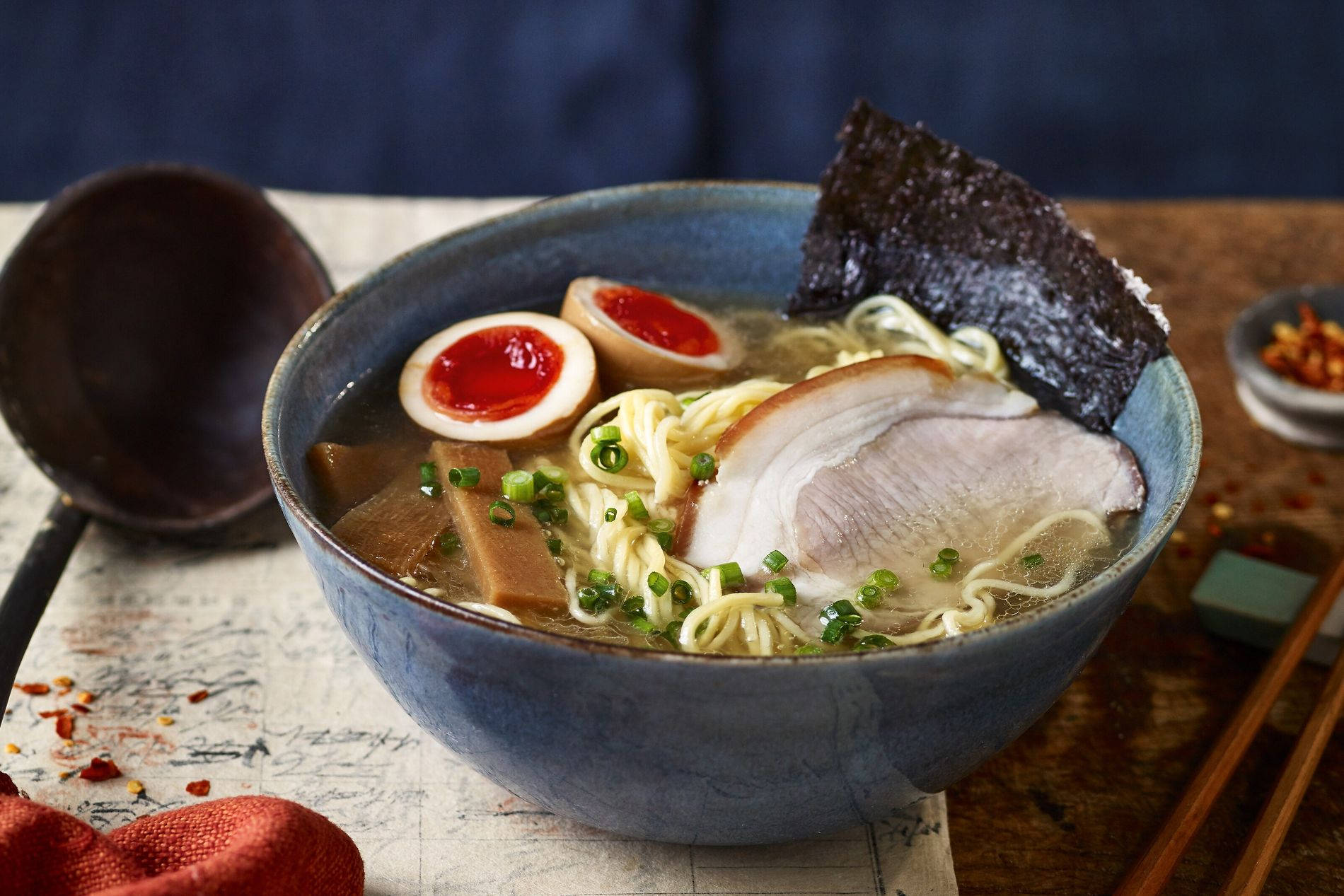 Food Photography 桌布 壁紙 — 一碗熱騰騰的拉麵，配有溏心蛋、豬肉片和海苔，並以青蔥點綴。