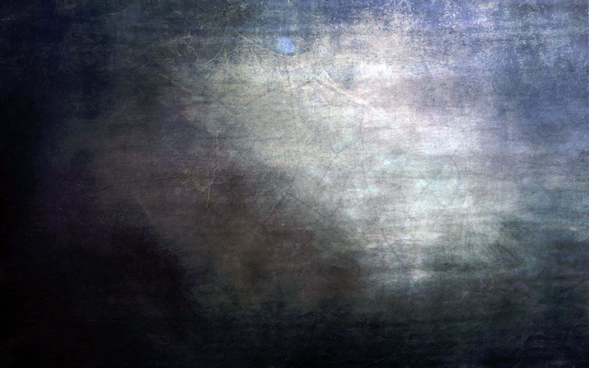 Grunge Texture 桌布 壁紙 — 一種帶有深藍色和灰色色調的陰鬱抽象紋理，由柔和發光的中心照亮。