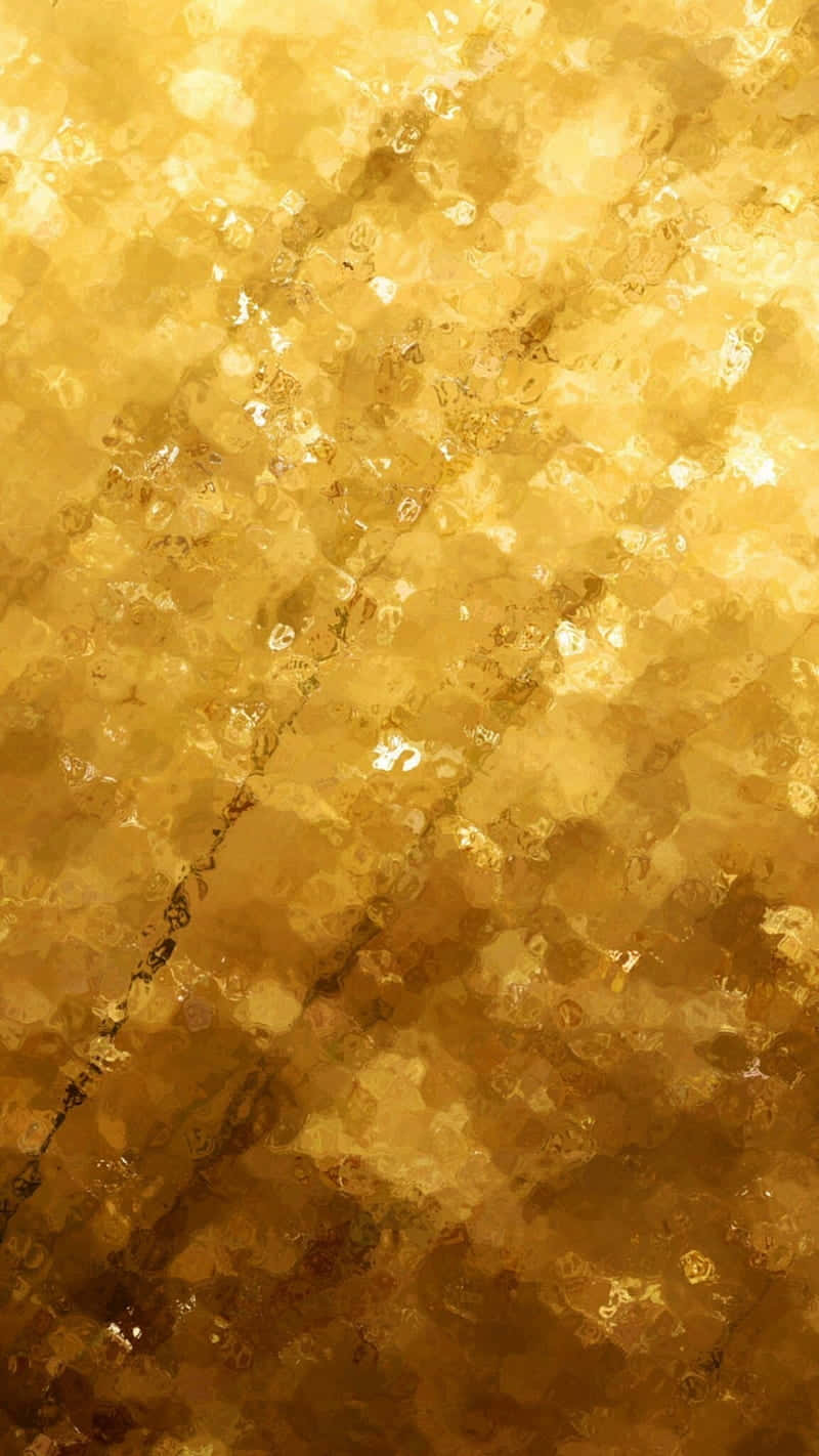 Metallic Gold 桌布 壁紙 — 一種閃耀的金色抽象紋理，帶有閃爍的高光和有機漩渦，讓人聯想到熔化的金屬或蜂巢。