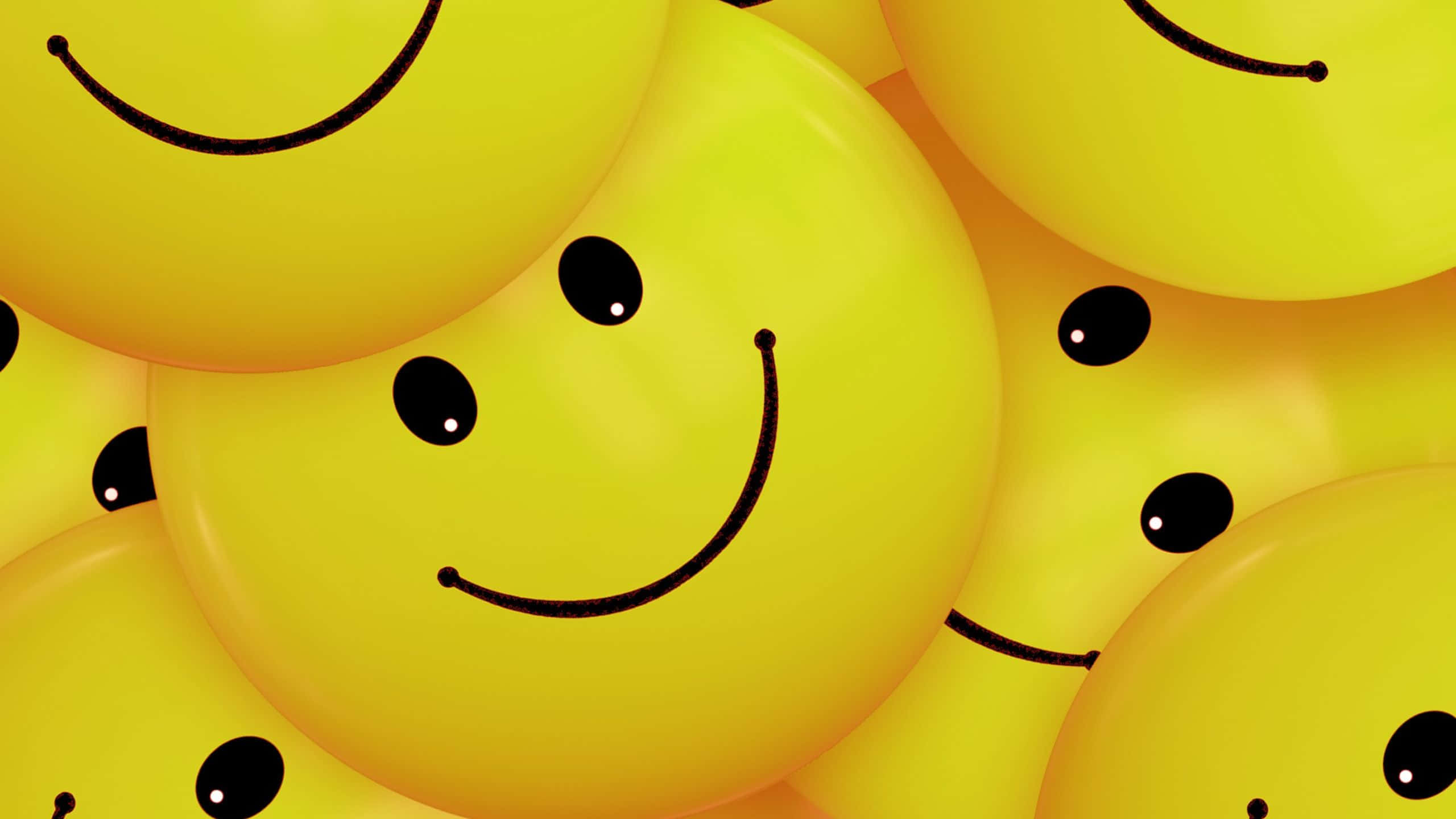 Smile Emoji 桌布 壁紙 — 一簇鮮黃色的氣球，每個都畫上簡單的笑臉，營造出歡樂和俏皮的氛圍。
