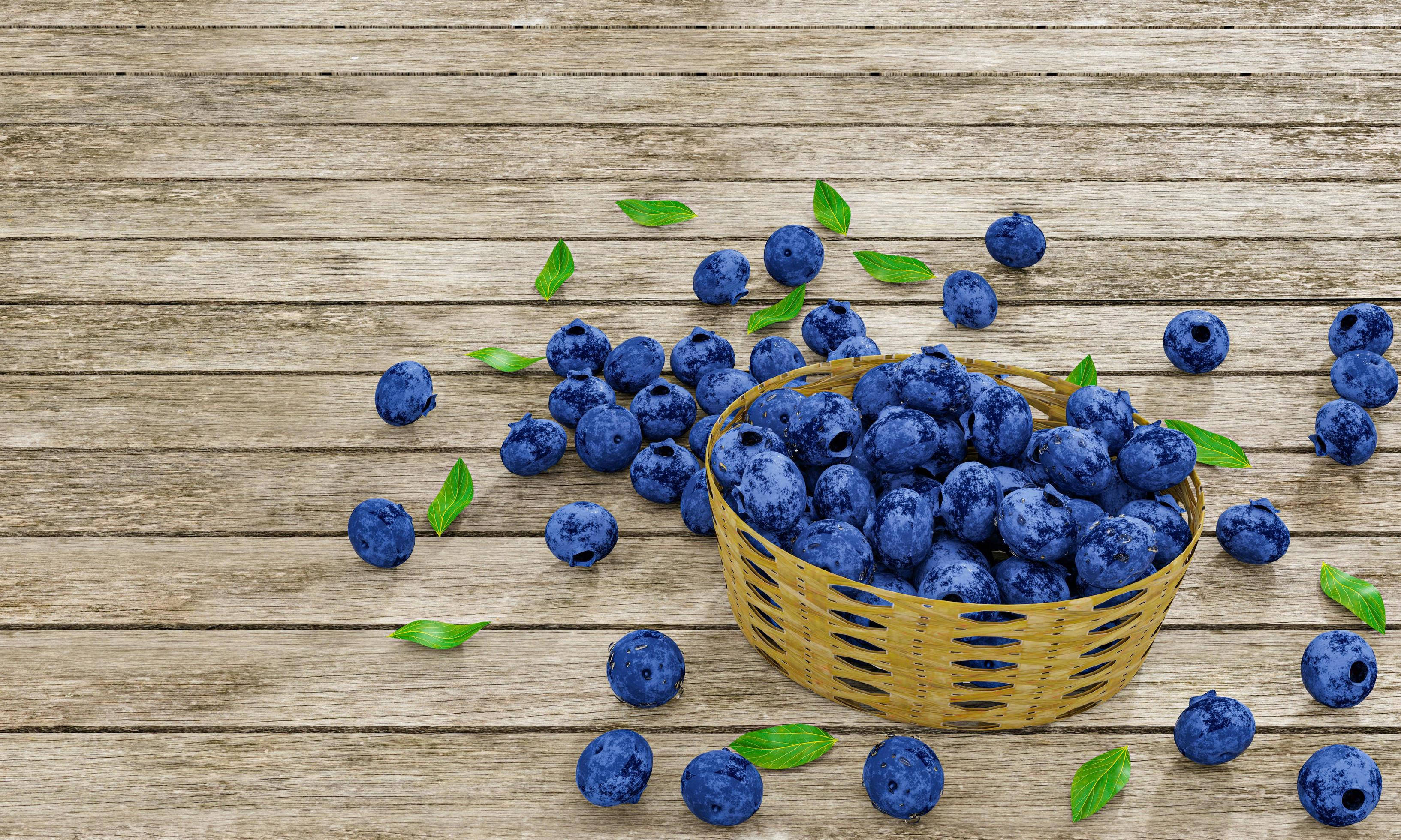 Fruits 桌布 壁紙 — 一籃飽滿的藍莓灑落在風化的木質表面上，散落著綠葉。