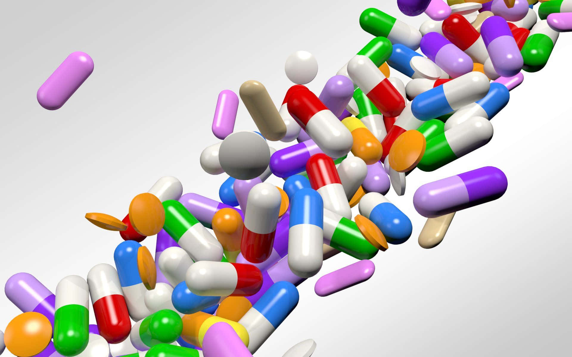 pills 桌布 壁紙 — 一系列色彩繽紛的藥丸和膠囊動態地沿對角線落在純白色背景上。