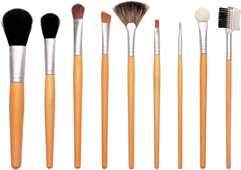 Makeup Kit 桌布 壁紙 — 一組八支化妝刷，木製手柄和銀色金屬箍，在黑色背景上排成一排。