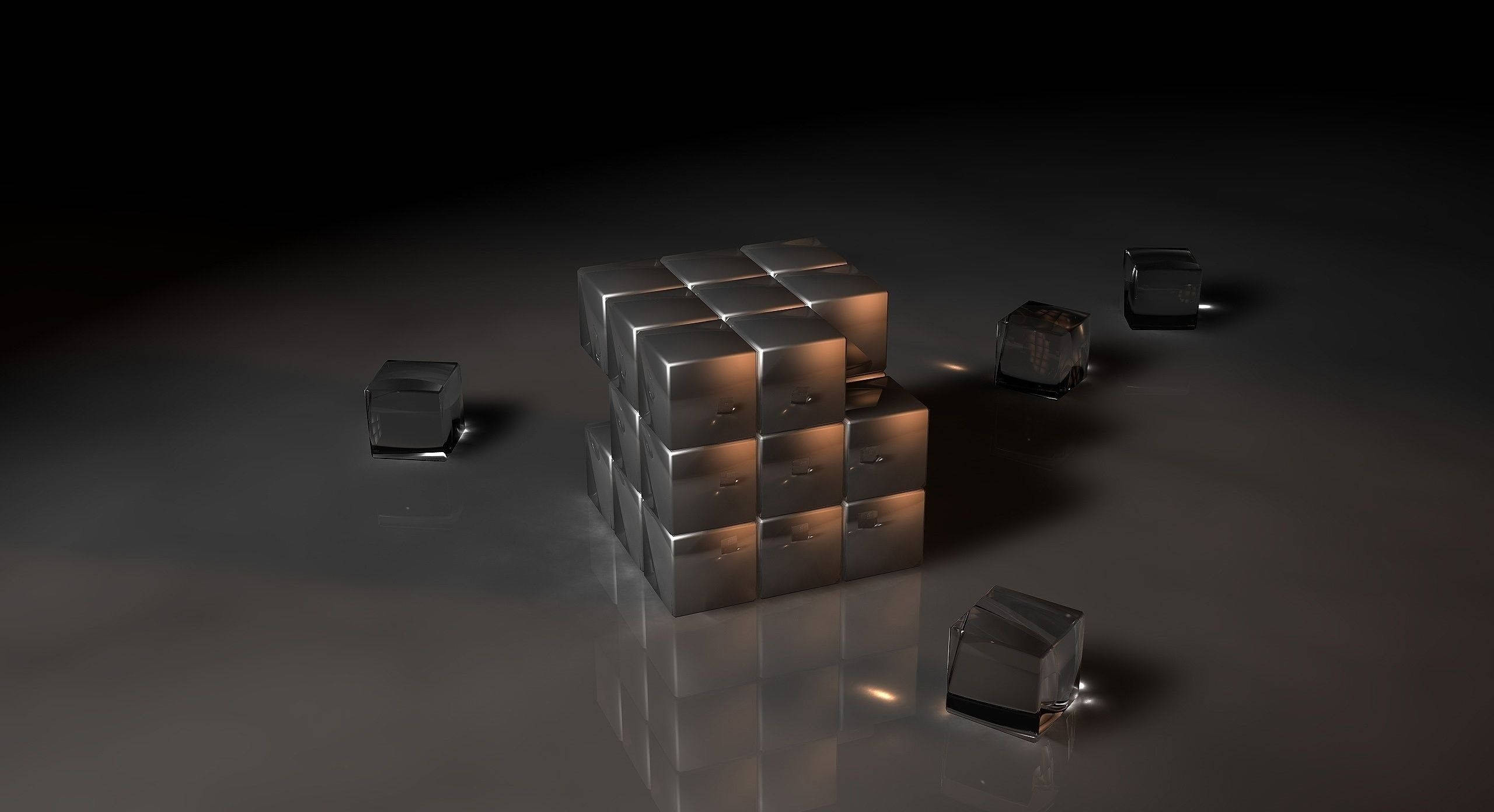 3D 桌布 壁紙 — 一組反光金屬立方體排列成立方體形狀，置於深色光澤地板上，周圍散落著單個立方體。
