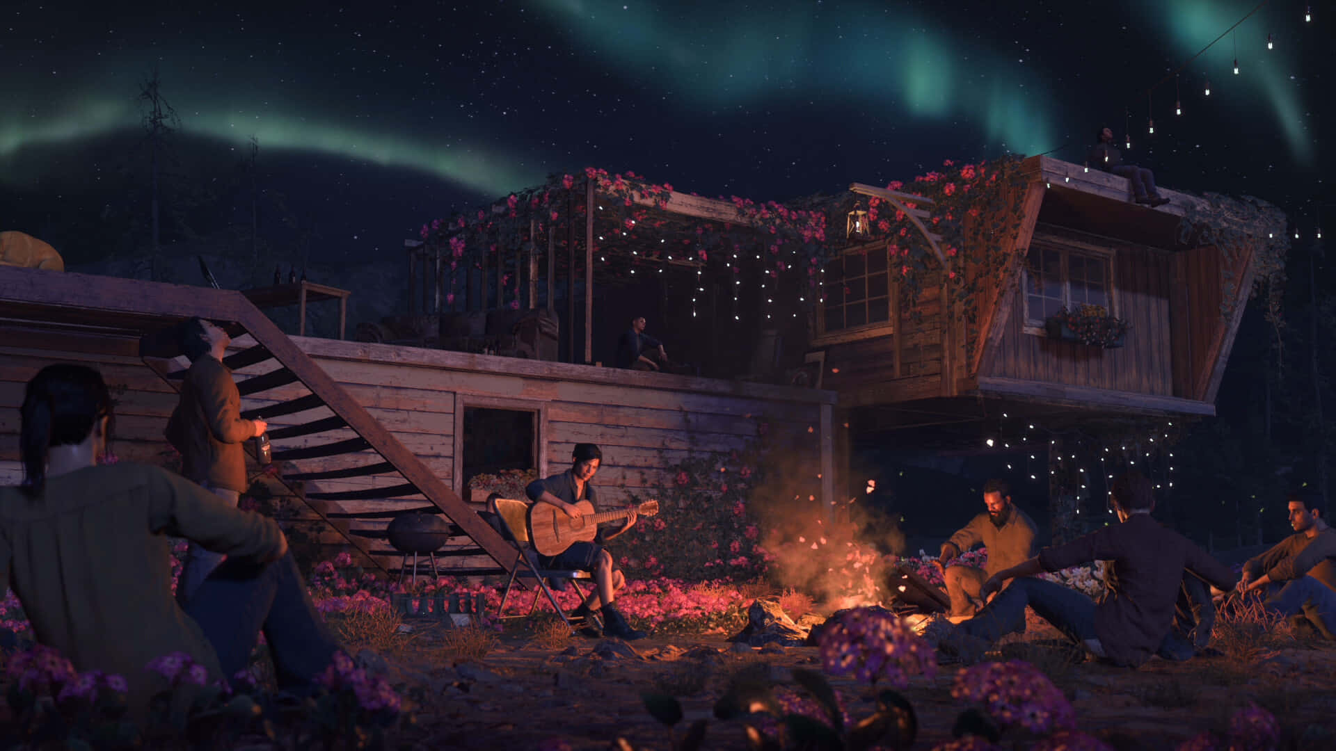 一群人坐在小屋前，背景是極光 壁紙