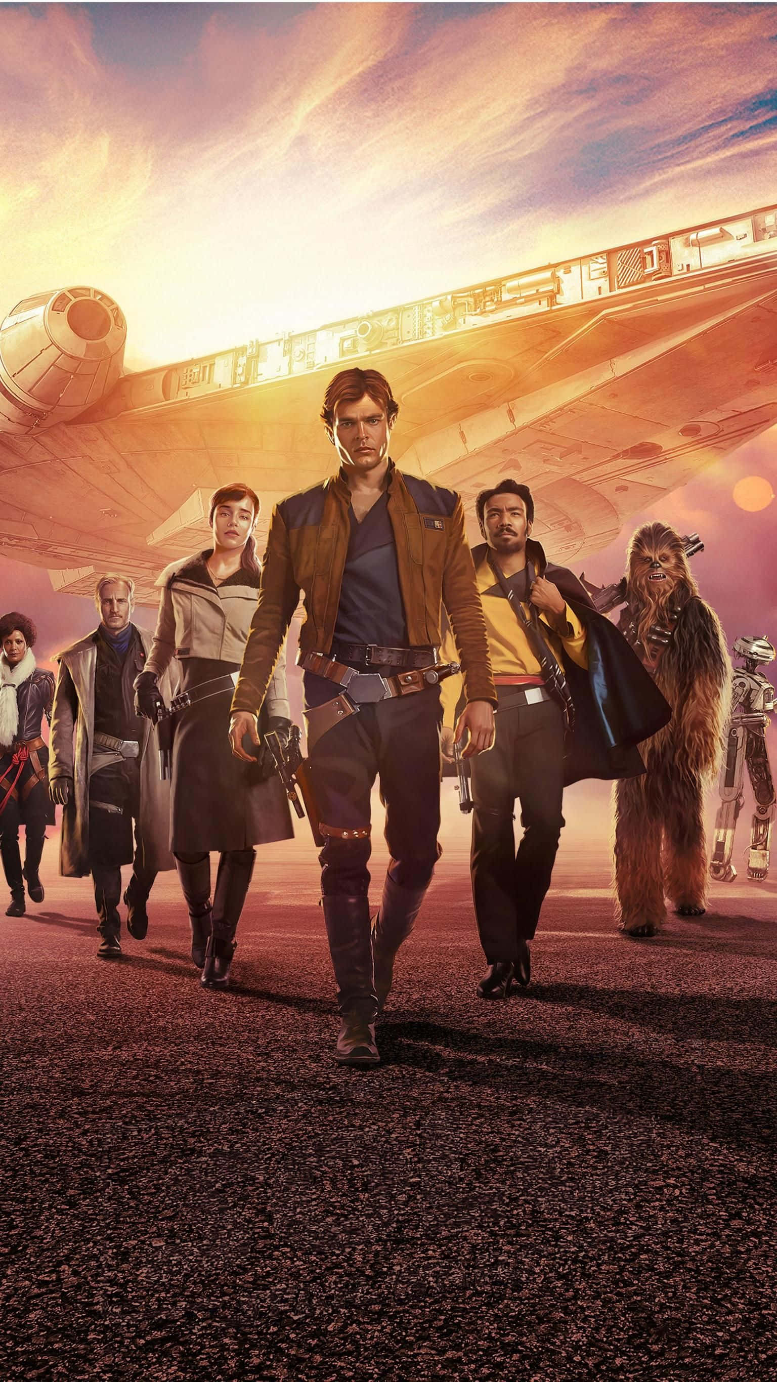 Solo A Star Wars Story 桌布 壁紙 — 一群叛軍自信地走向觀眾，背景是巨大的太空船和熾熱的日落天空。