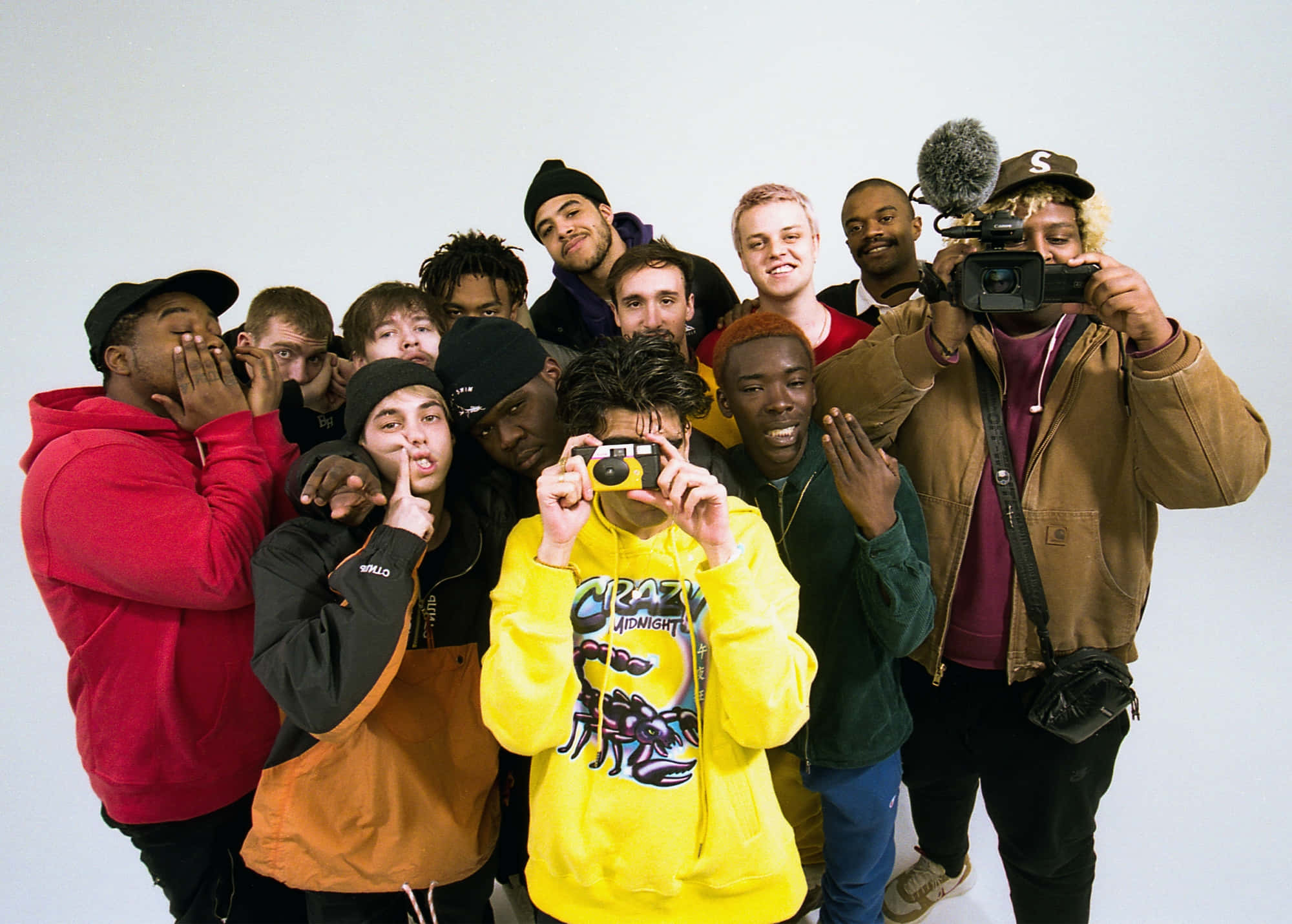 Brockhampton 桌布 壁紙 — 一群多元化的年輕男性穿著色彩繽紛的街頭服飾，在純白背景前與相機俏皮地擺姿勢。