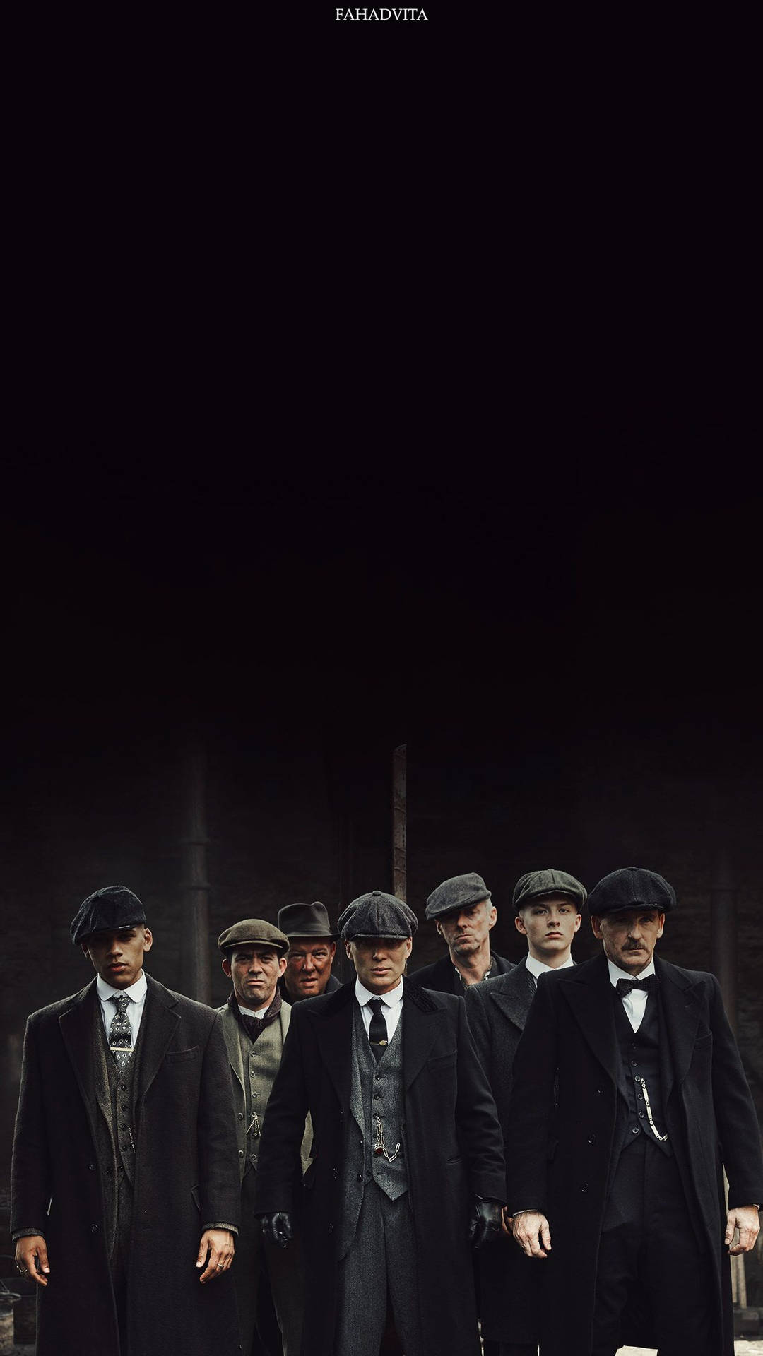 七名戴平頂帽和西裝的男子站在黑暗的城市環境中。 — Peaky Blinders 壁紙