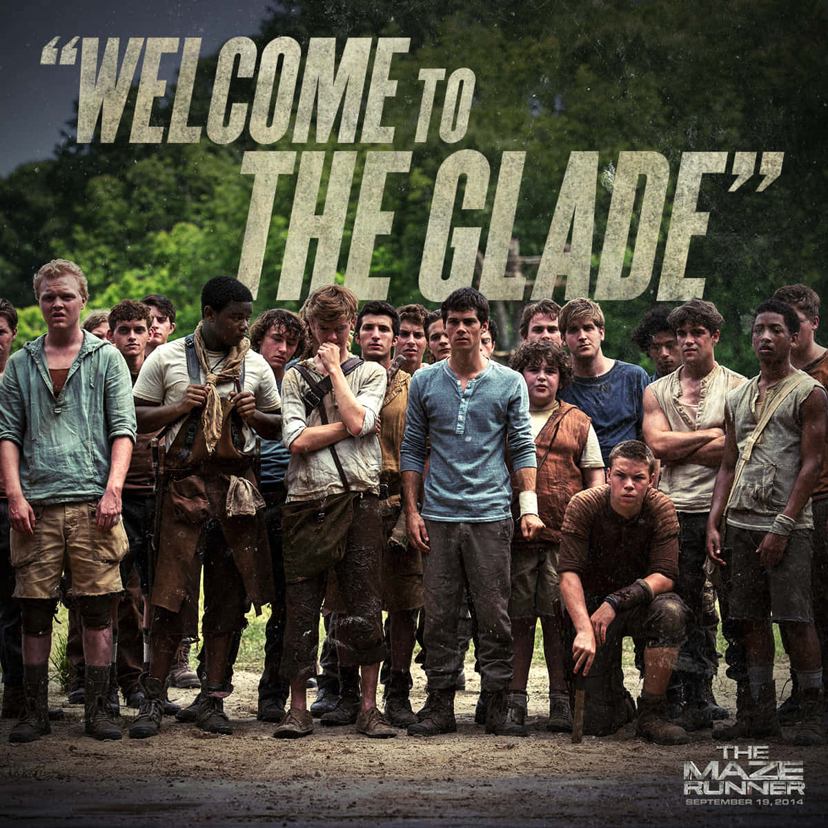 Maze Runner 桌布 壁紙 — 一群滿身泥濘的年輕男子在黑暗天空下的森林空地中挑釁地站立，粗體文字寫著「WELCOME TO THE GLADE」。