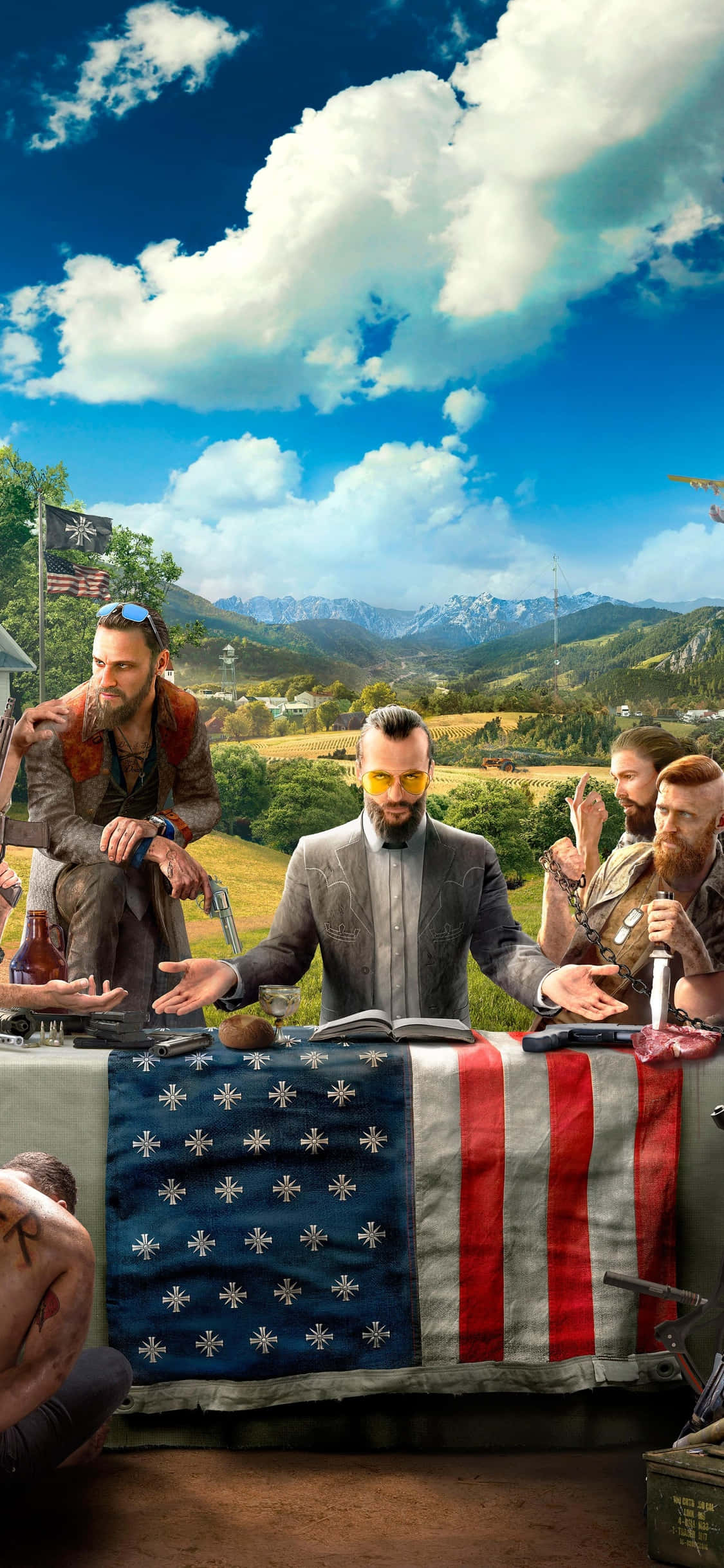 iPhone Xs Far Cry 5 桌布 壁紙 — 一群粗獷的男子聚集在一張鋪有美國國旗的桌子周圍，背景是晴朗藍天下的山區戶外環境。