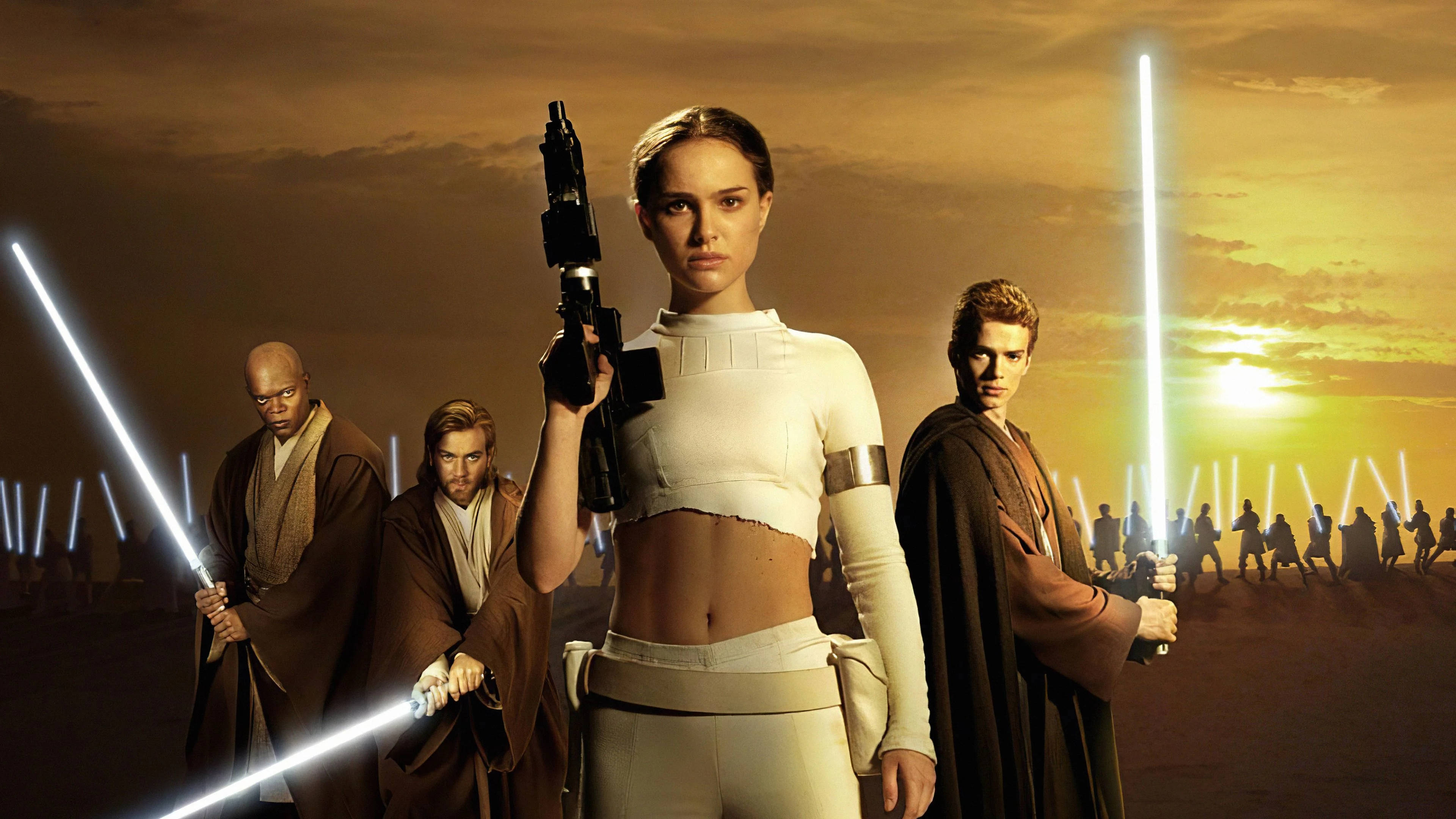 Star Wars Characters 桌布 壁紙 — 一群絕地武士站在沙漠中，夕陽下手持發光的光劍，表情堅定。